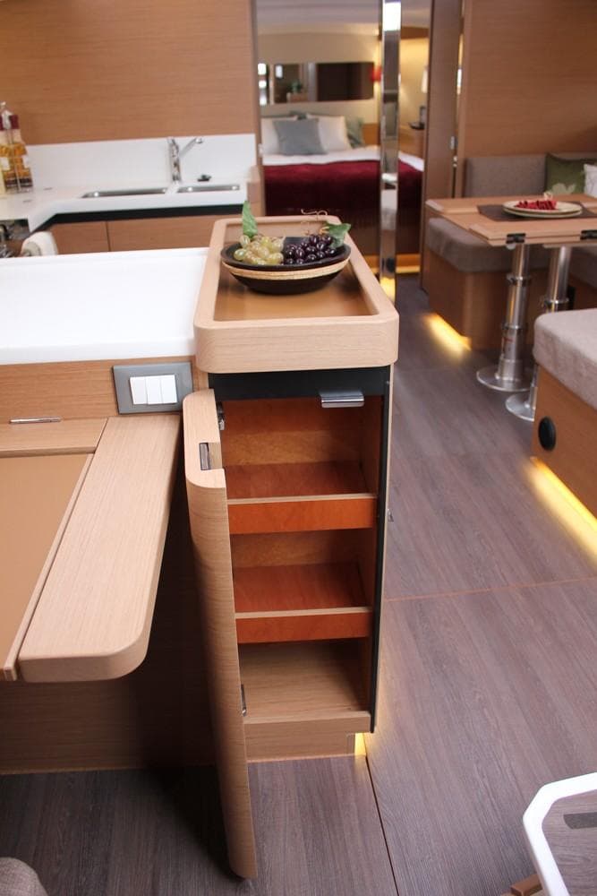 Interior of 2025 Jeanneau Sun Odyssey 440 yacht, featuring modern kitchen and storage.