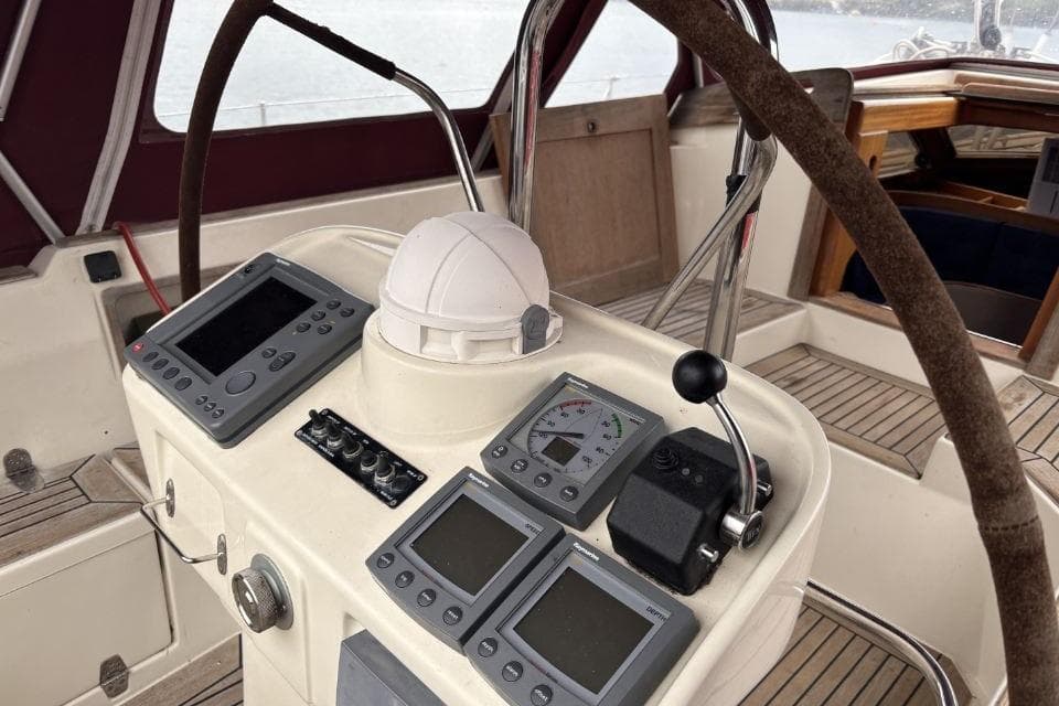 Cockpit of a 2004 Regina 43 yacht with navigation instruments and steering wheel.