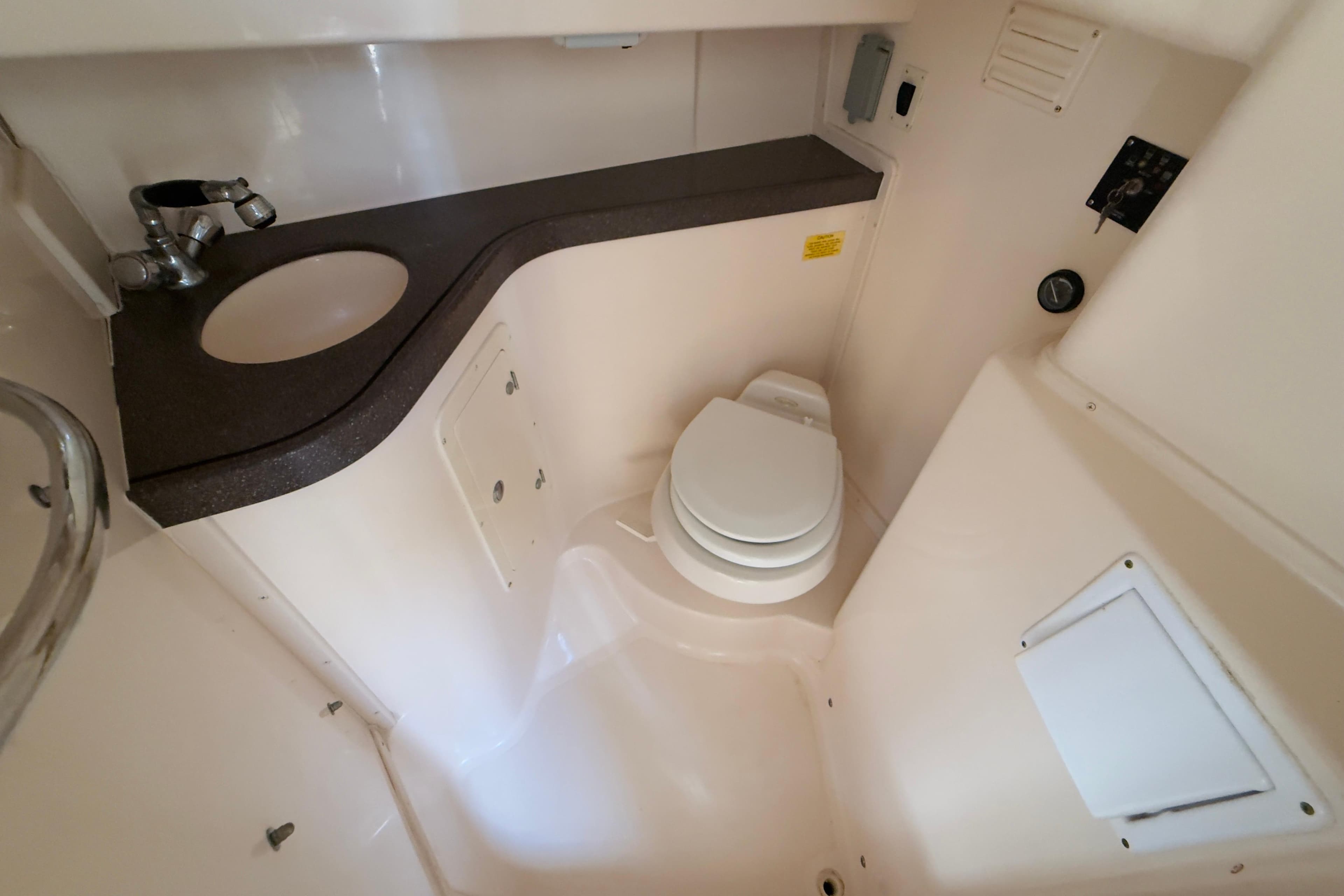 2005 Grady-White Express 330 boat bathroom with sink and toilet.
