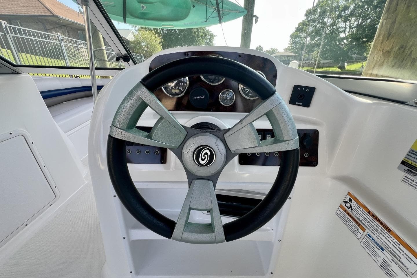 Steering wheel and dashboard of 2013 Hurricane SunDeck 187 OB boat.