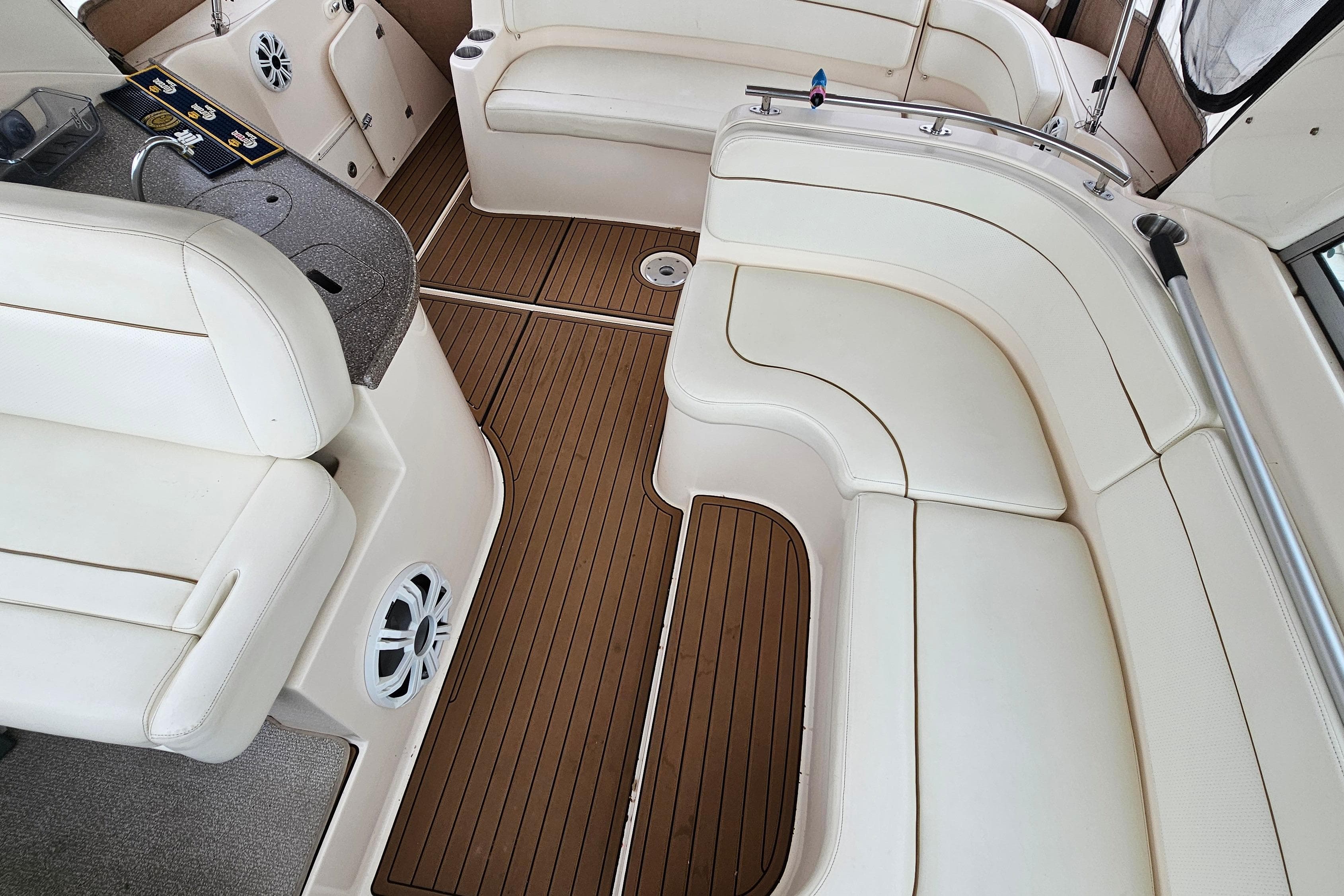 2004 Rinker Fiesta Vee 312 boat interior with white seating and wood flooring.