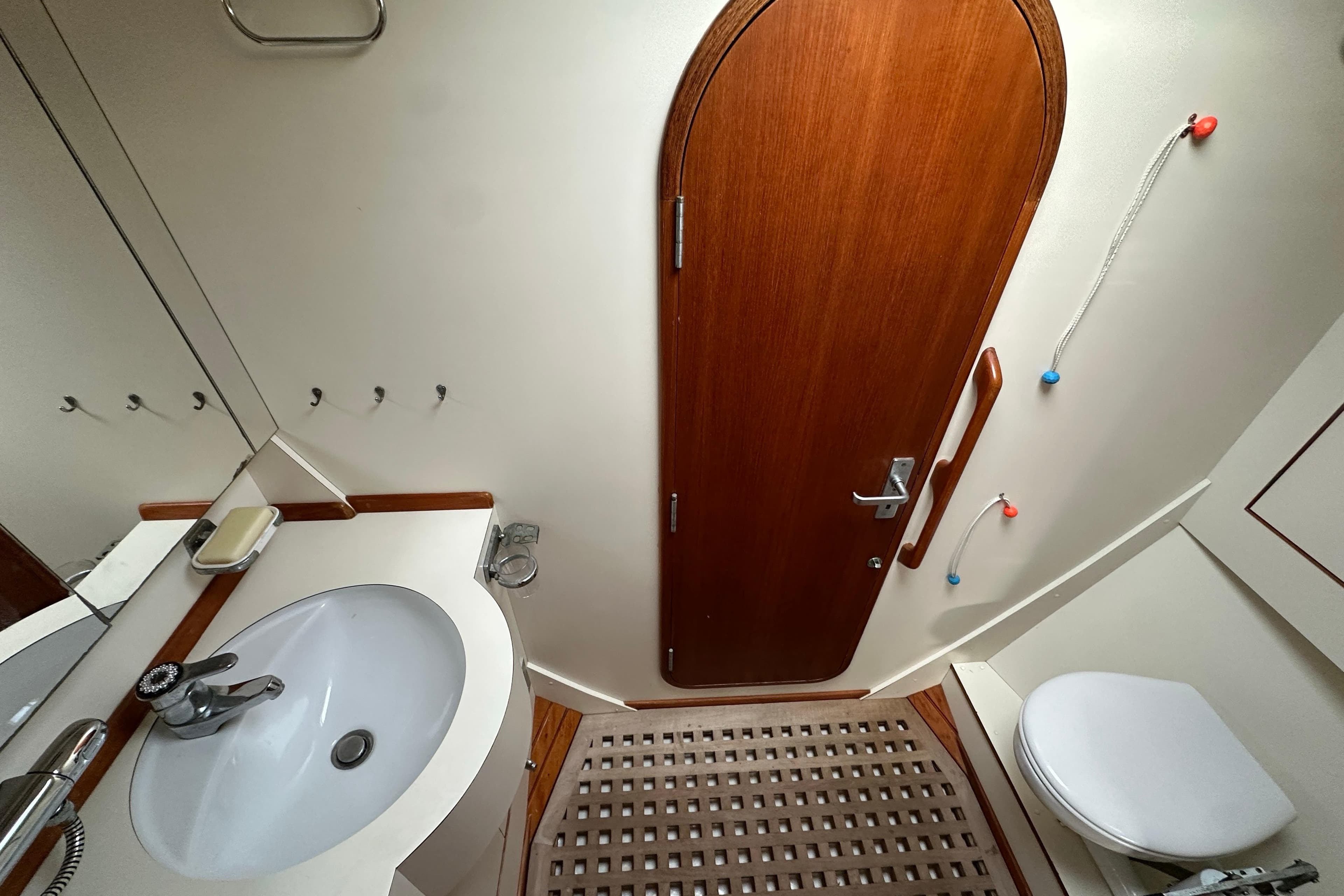 Bathroom interior of 1991 Standfast 56 yacht with wooden door and modern fixtures.