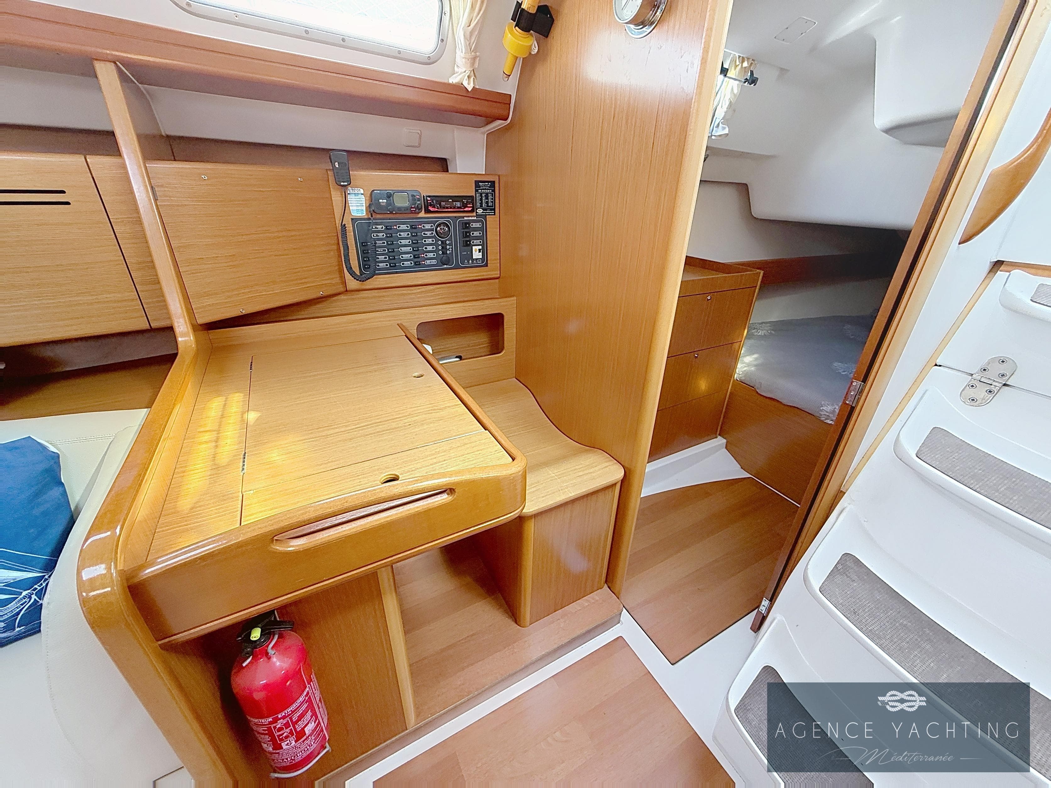 2007 Beneteau Cyclades 39 interior with navigation station and wooden cabinetry.