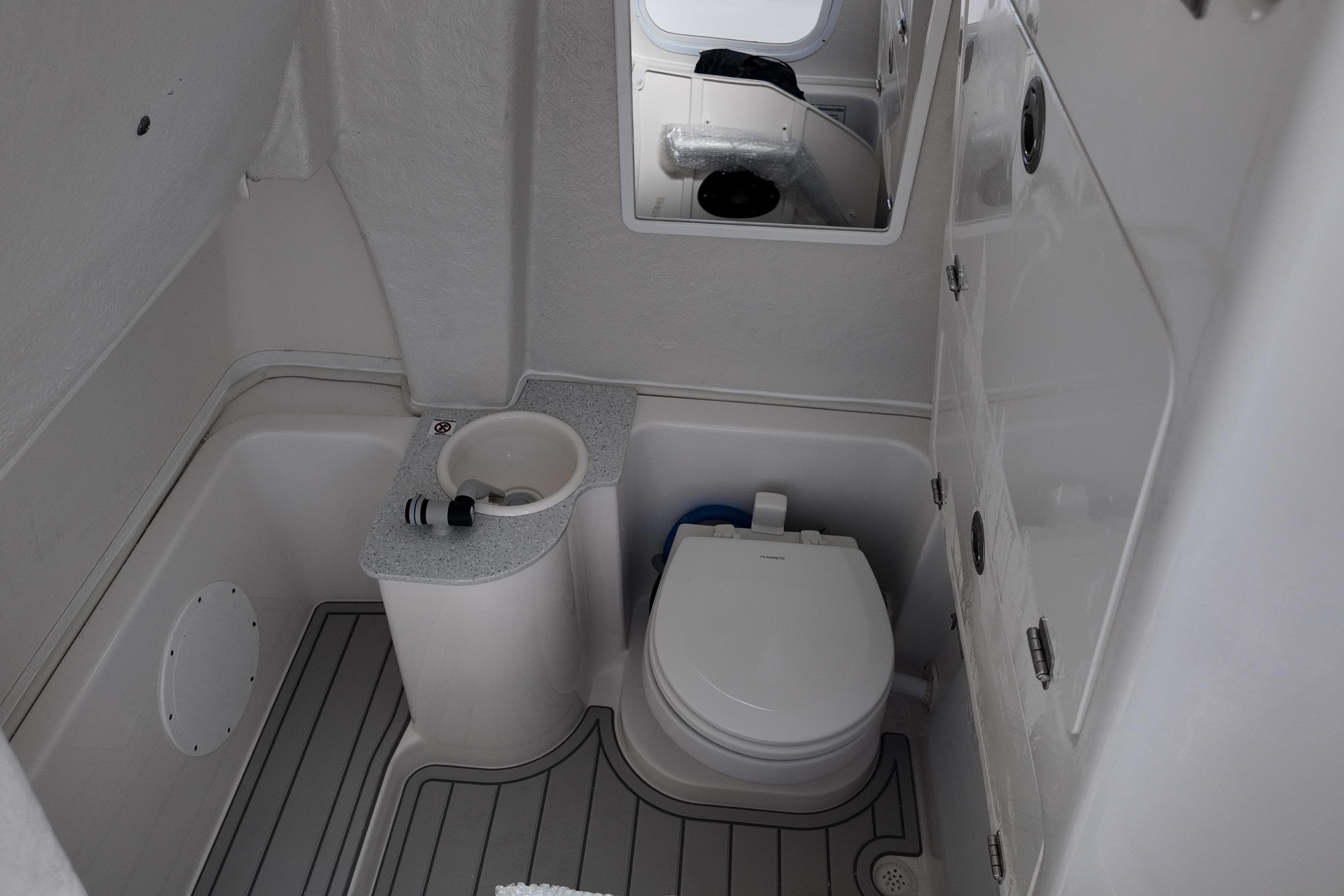 2026 Sea Fox 268 Commander boat bathroom with toilet and sink.