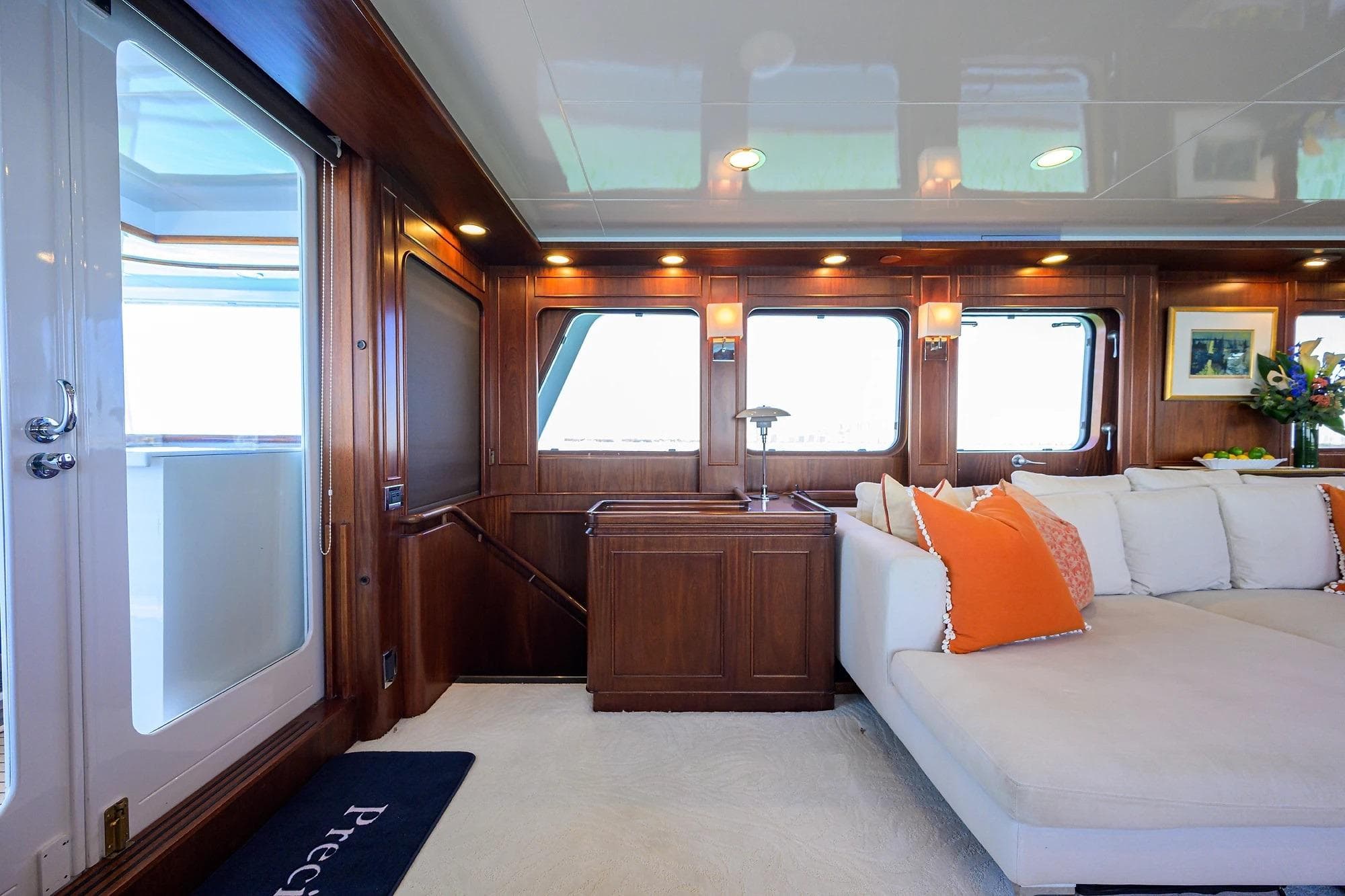 Luxurious interior of 1986 Jongert 85 yacht with elegant wood paneling and plush seating.