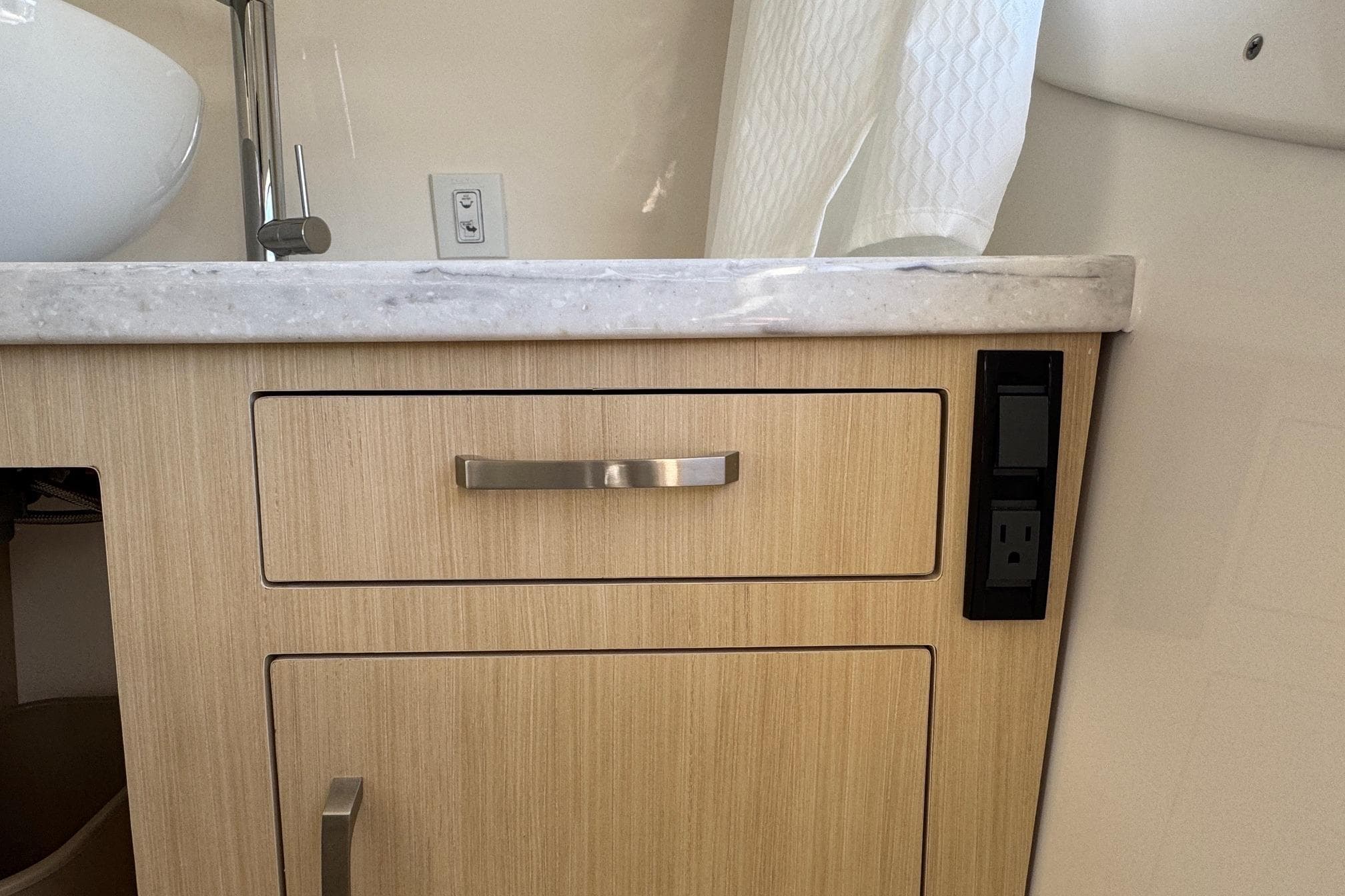 2026 Regal 33 XO yacht bathroom with wooden cabinet and marble countertop.