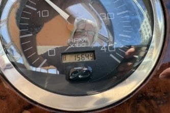 Close-up of a 2001 Sea Ray 380 Sundancer tachometer displaying 1564.9 hours.