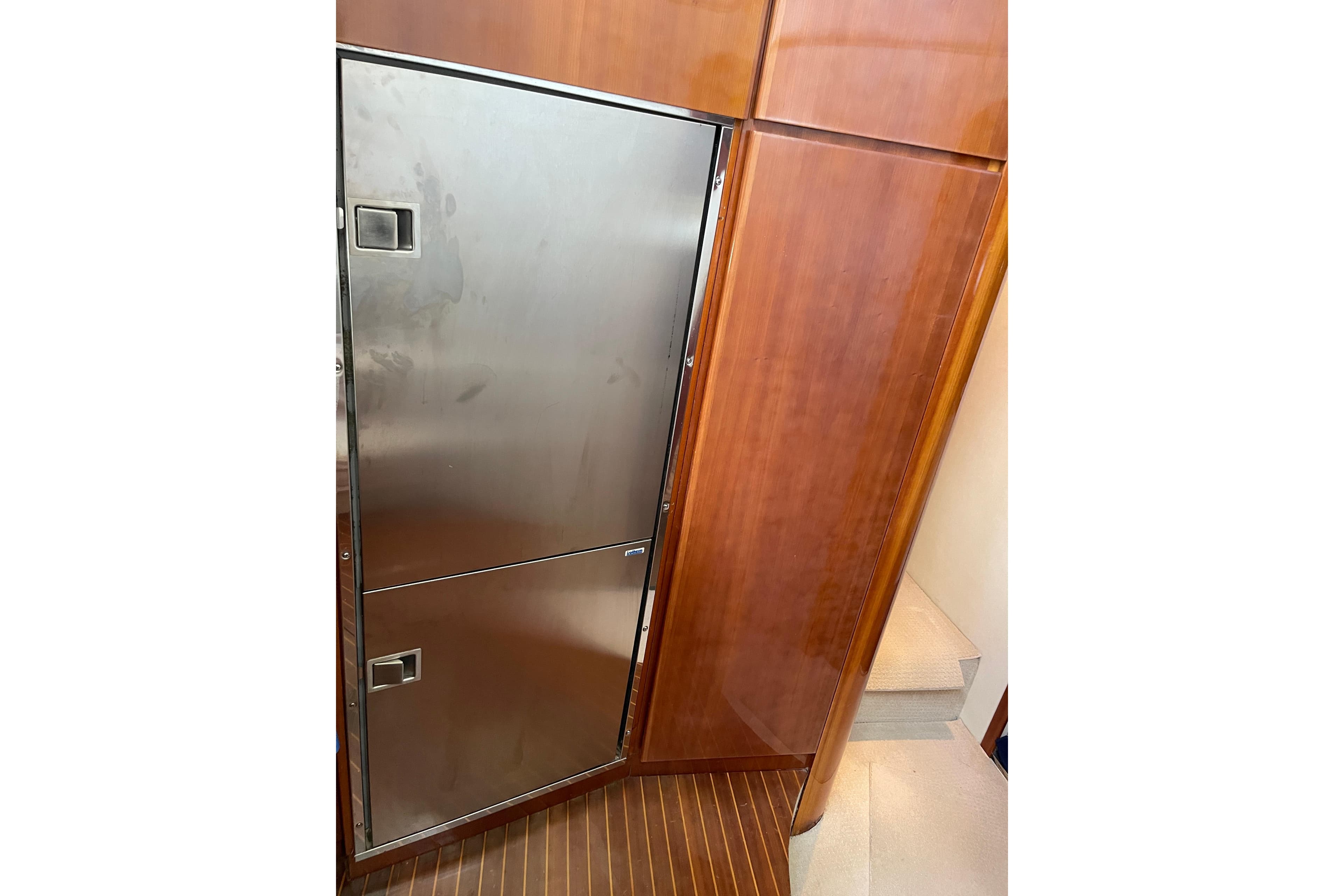 Stainless steel fridge on Azimut 46 Flybridge MY, 2000 model, with wooden cabinetry.