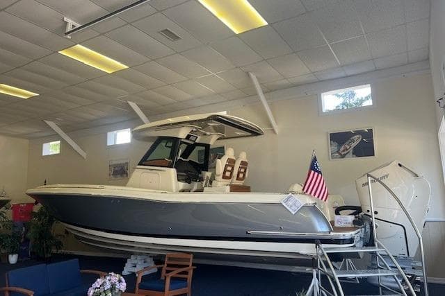 2026 Chris-Craft Catalina 31 boat displayed indoors with American flag.