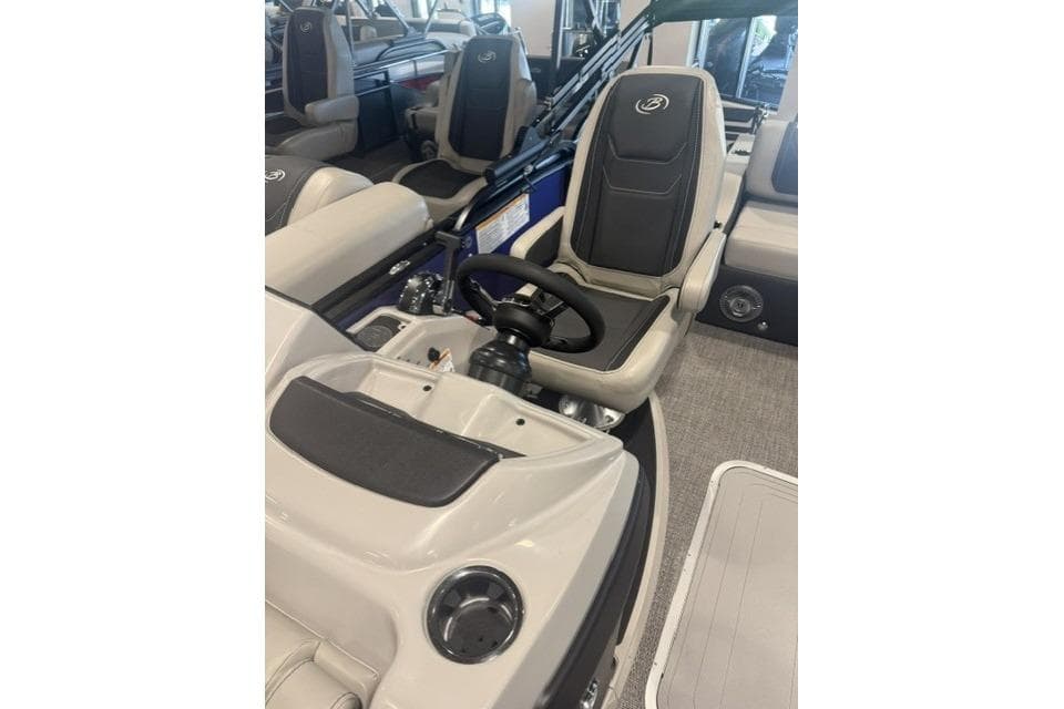 Interior of 2026 Barletta Cabrio 24QC boat, featuring steering wheel and seating.