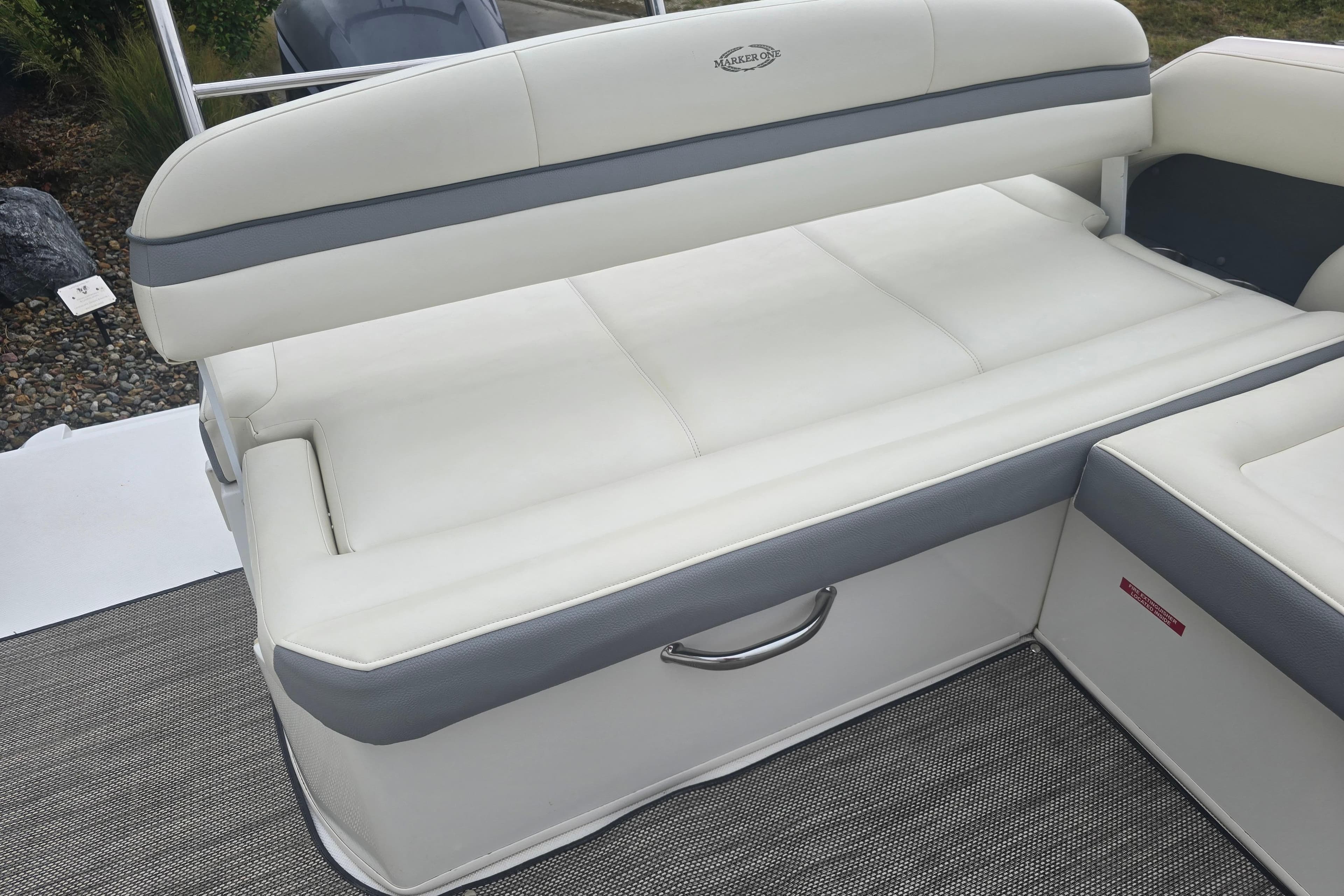 White and gray seating on 2016 Marker One ML4 boat, featuring sleek design and comfortable upholstery.