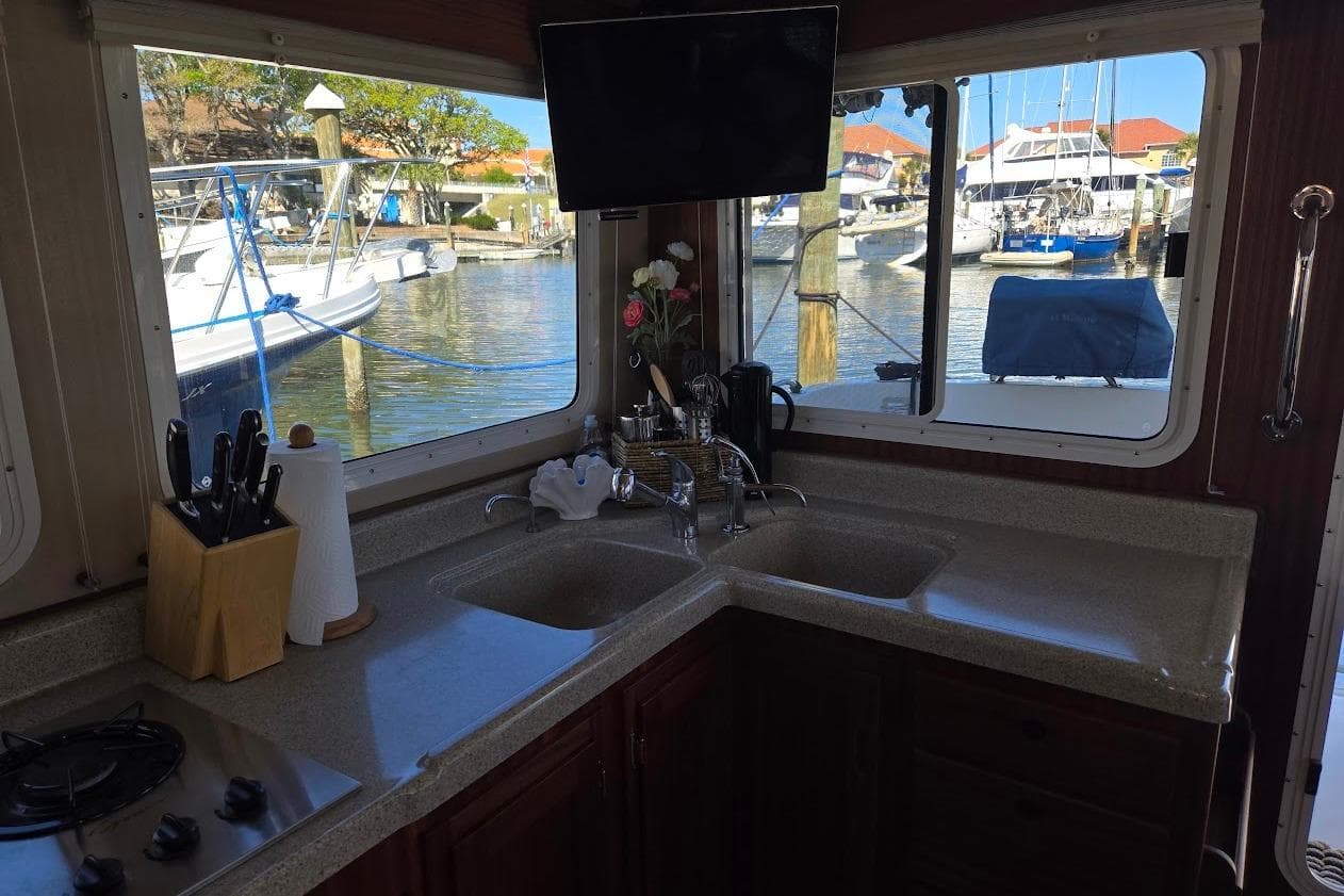 Cozy kitchen in 2010 American Tug "34" Pilothouse Trawler with marina view.