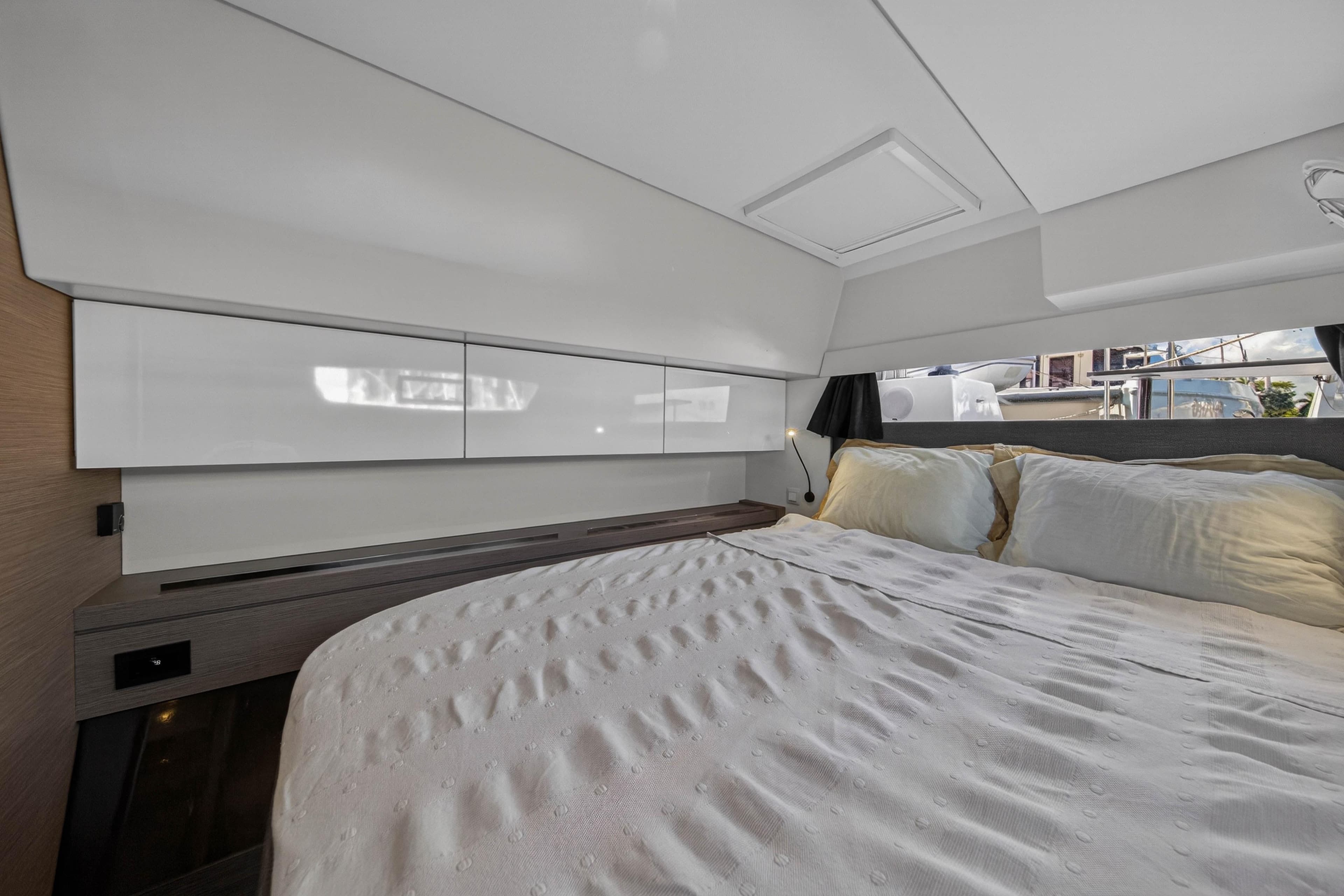 Luxurious cabin interior of 2022 Fountaine Pajot Tanna 47 yacht with comfortable bedding.