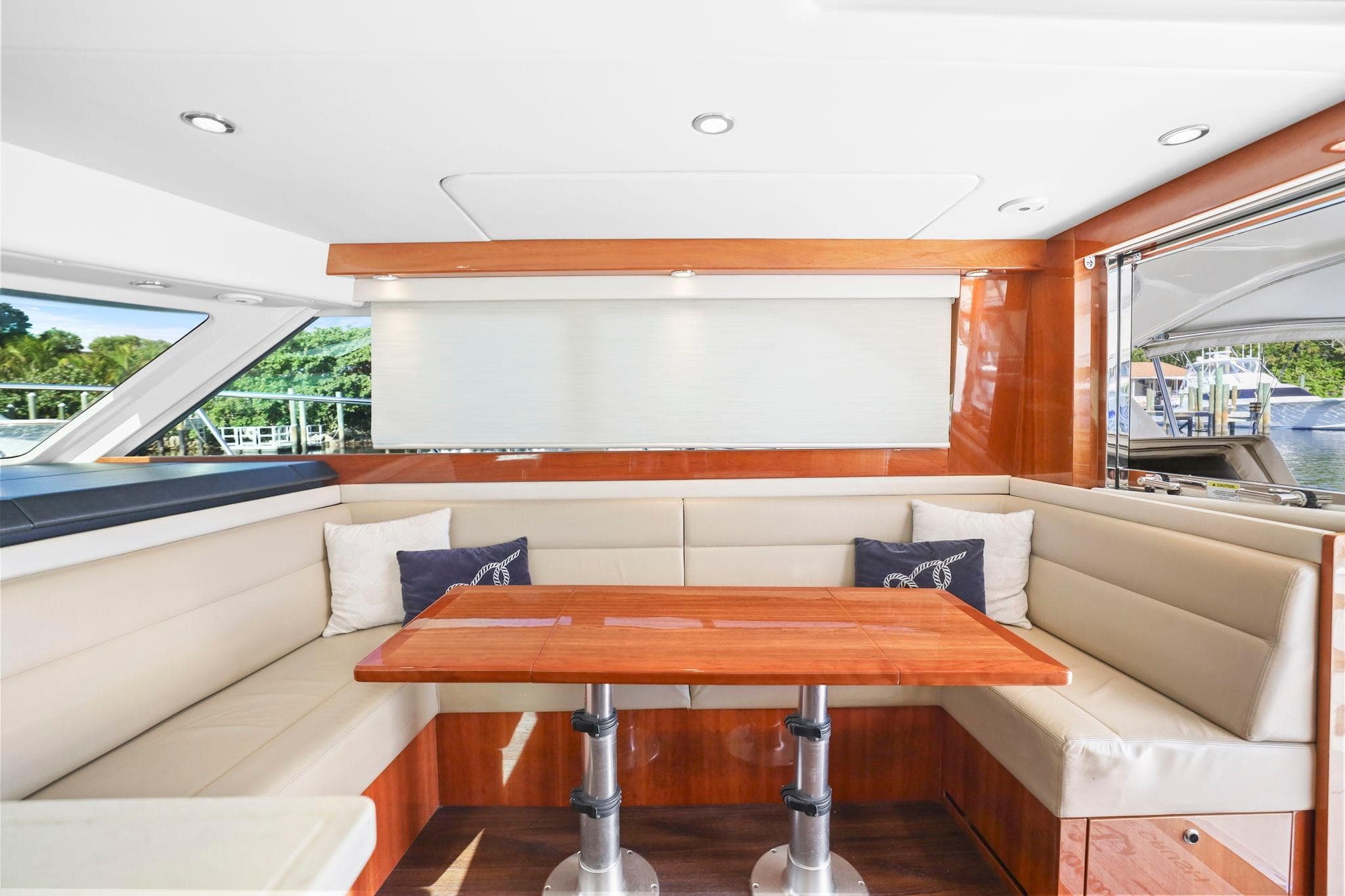 Luxurious interior of 2016 Riviera 43 Open Flybridge yacht with elegant seating and table.