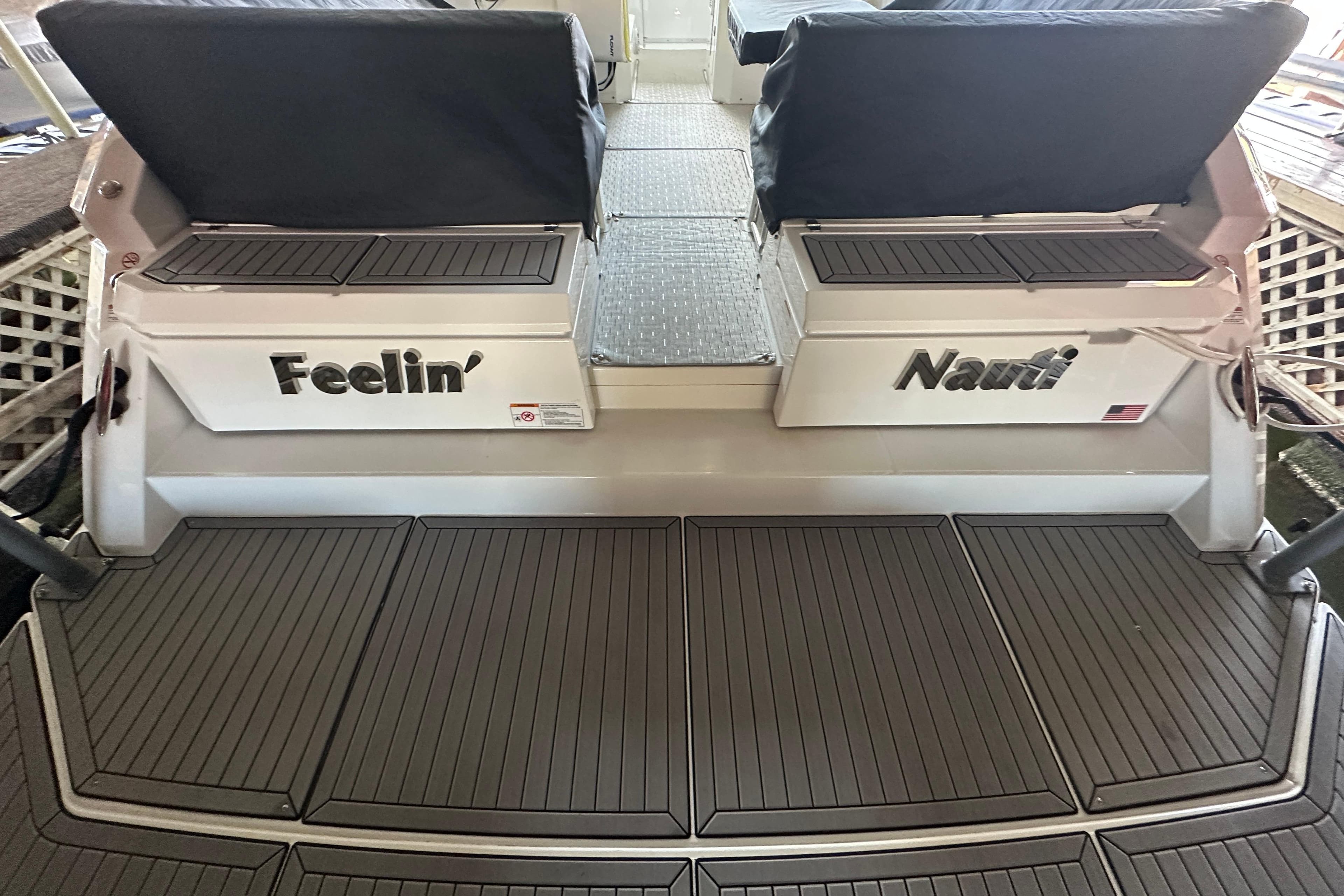 2021 Cruisers Yachts 390 Express Coupe swim platform with "Feelin' Nauti" text.