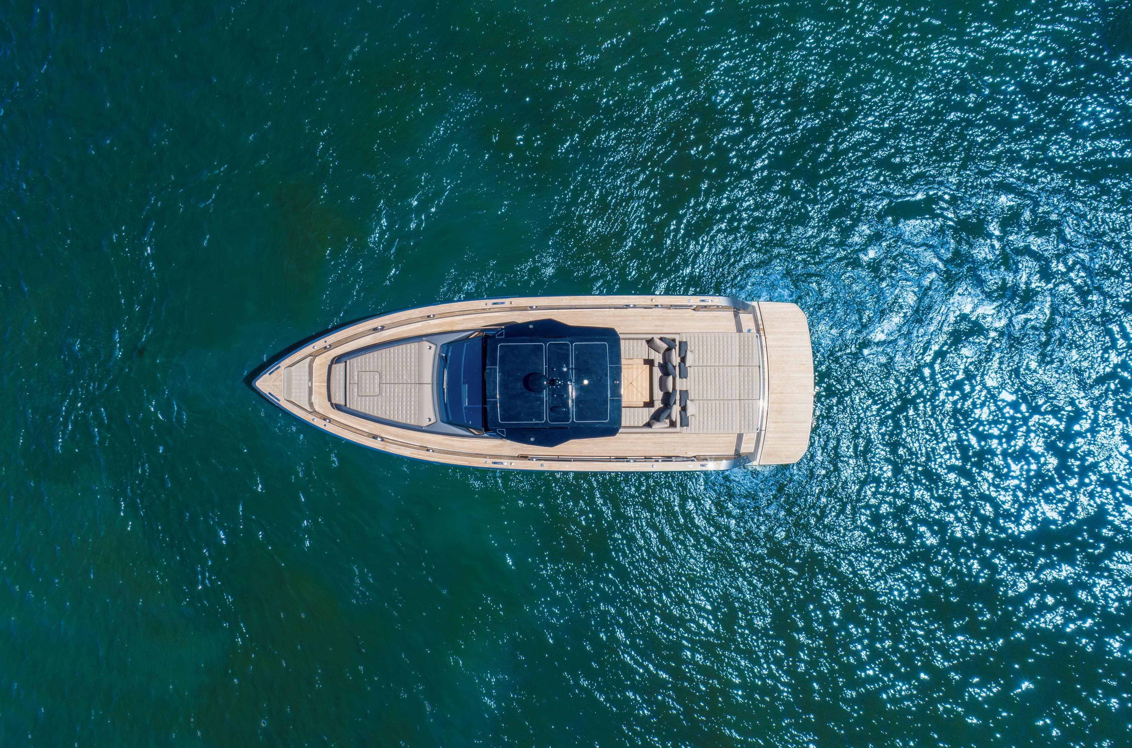 Aerial view of 2025 Pardo Yachts 50 model cruising on clear blue water.