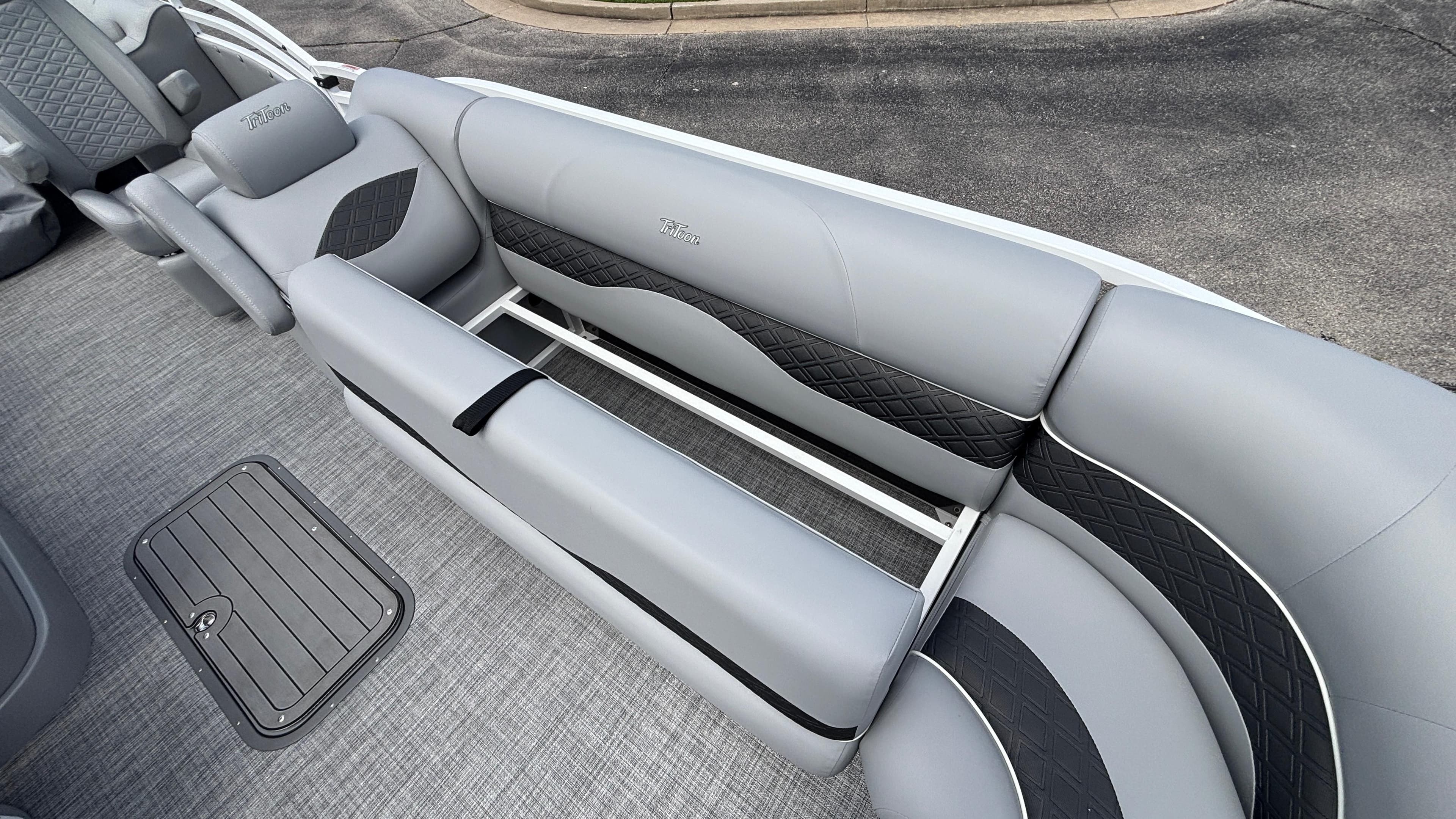 2025 JC Neptoon 25TT Sport boat interior with gray and black seating.