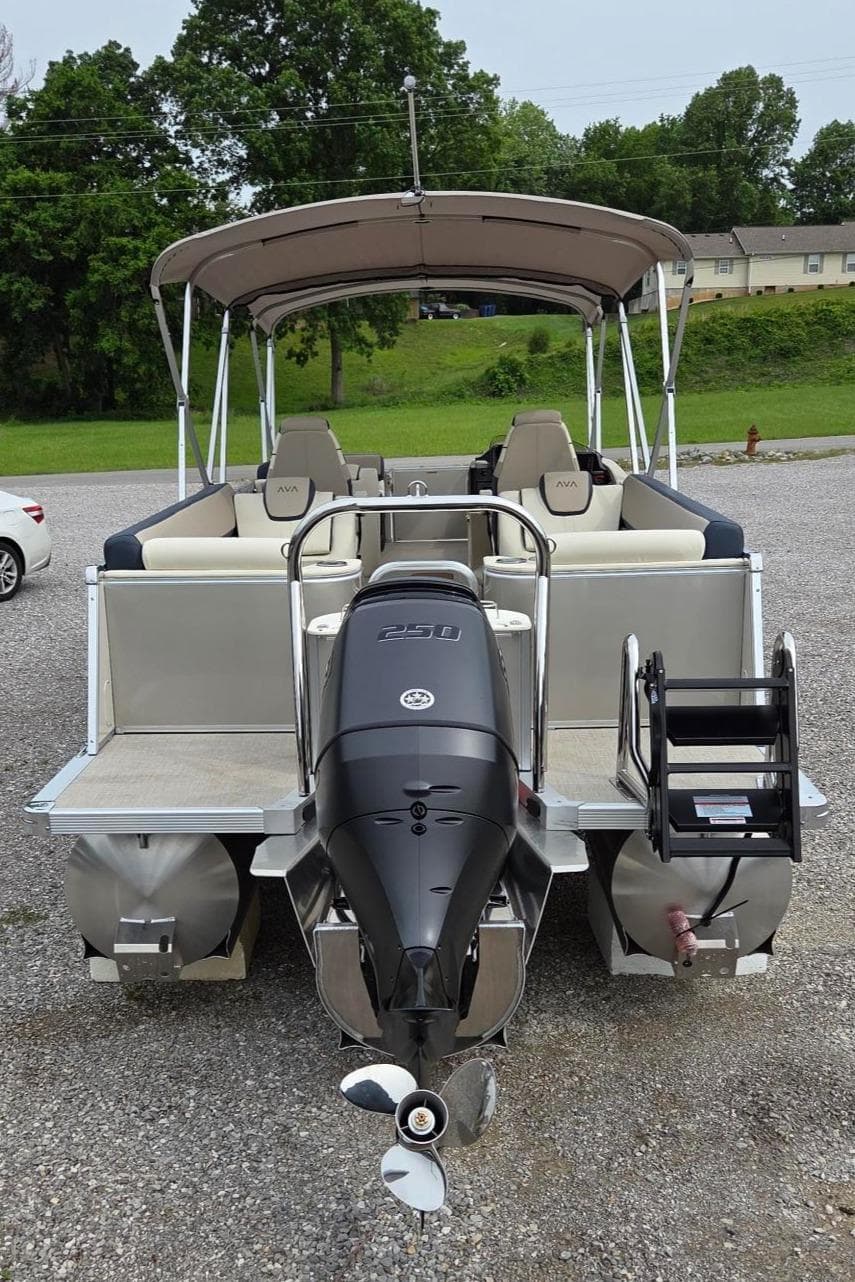 2025 Avalon Platinum Catalina 2585 Quad Lounger pontoon boat, rear view with outboard motor.