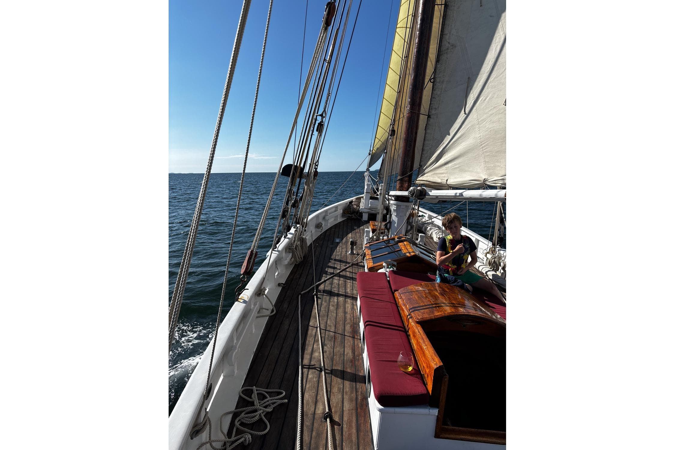 Sailing on a 2004 Custom Luke Powell Pilot Cutter, sunny day at sea.