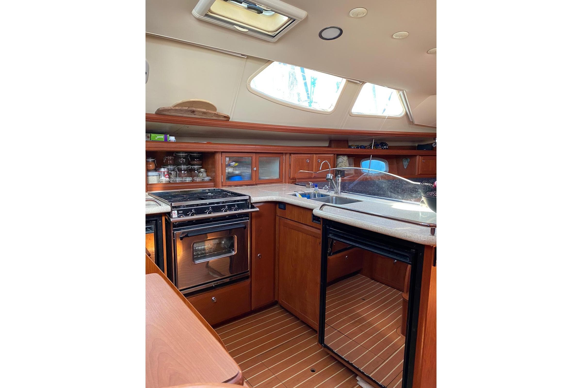 Interior of 2010 Hunter 45 Deck Salon yacht kitchen with stove and sink.