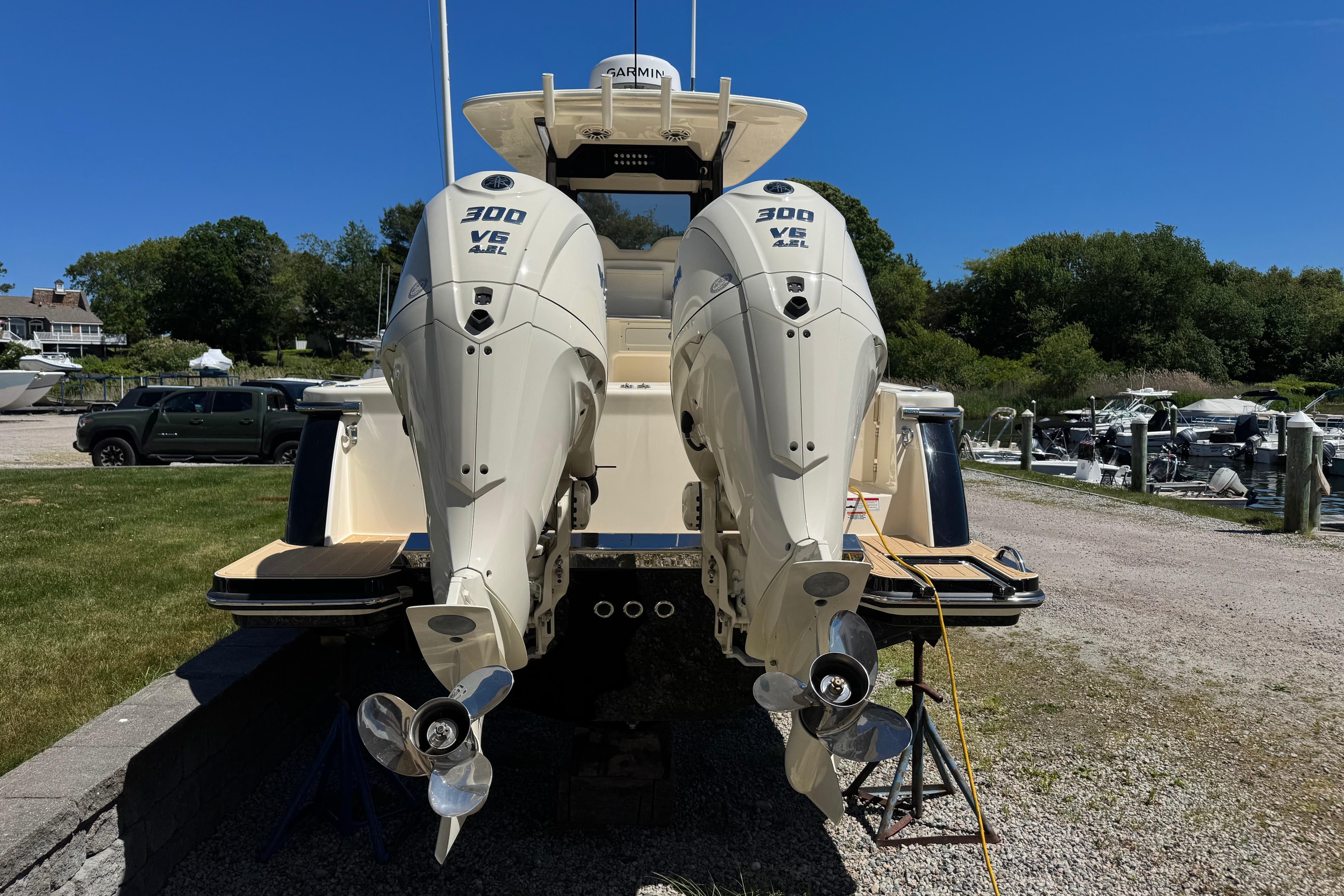 2026 Scout 288 LXF boat with twin 300 V6 engines at a marina.
