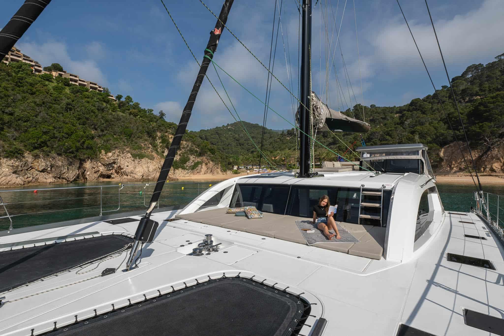 Luxury Privilege Signature 580 yacht anchored near scenic coastline, 2025 model.