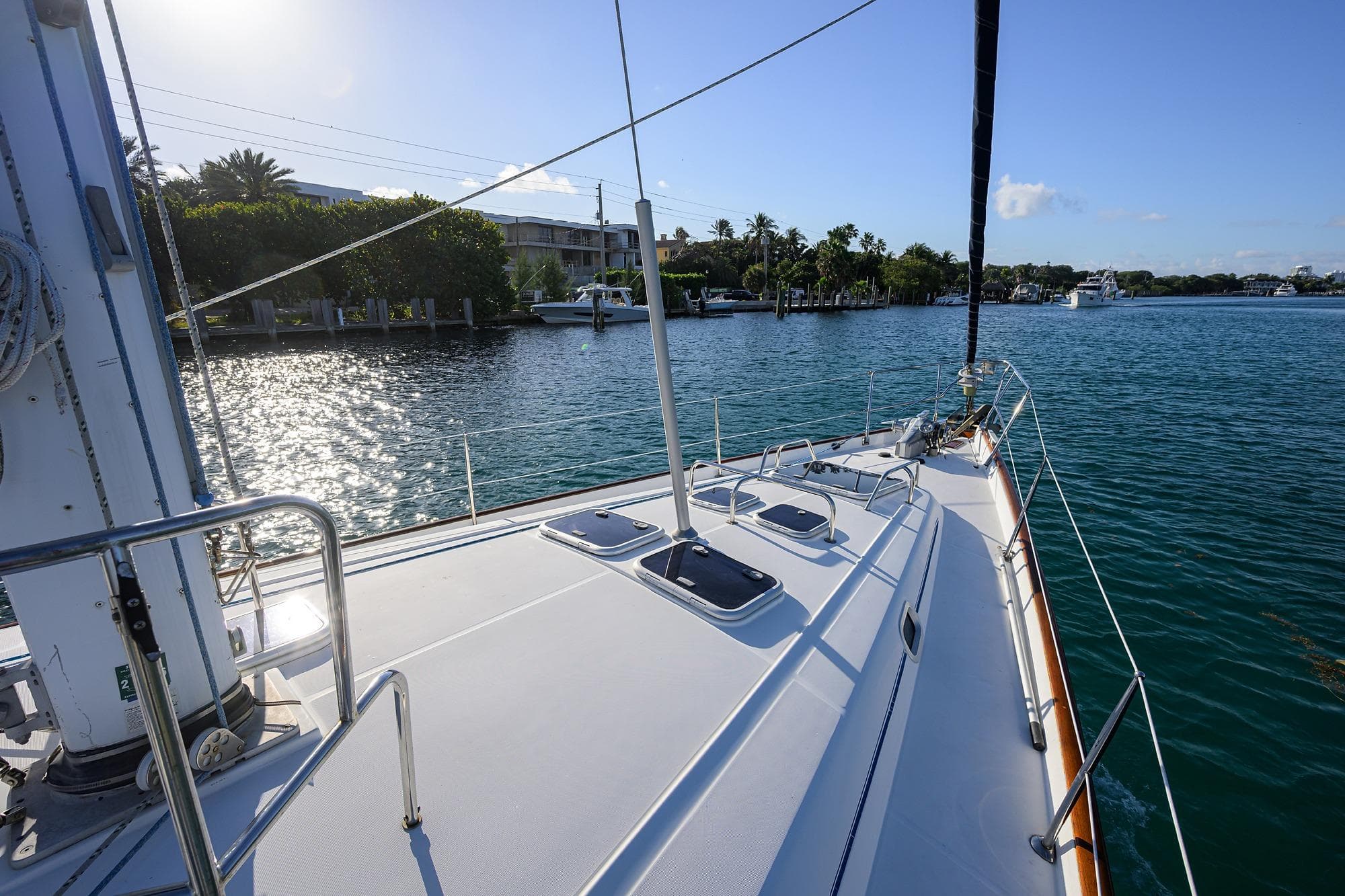 Deck view of 2003 Beneteau 50 sailboat on calm waters, sunny day.