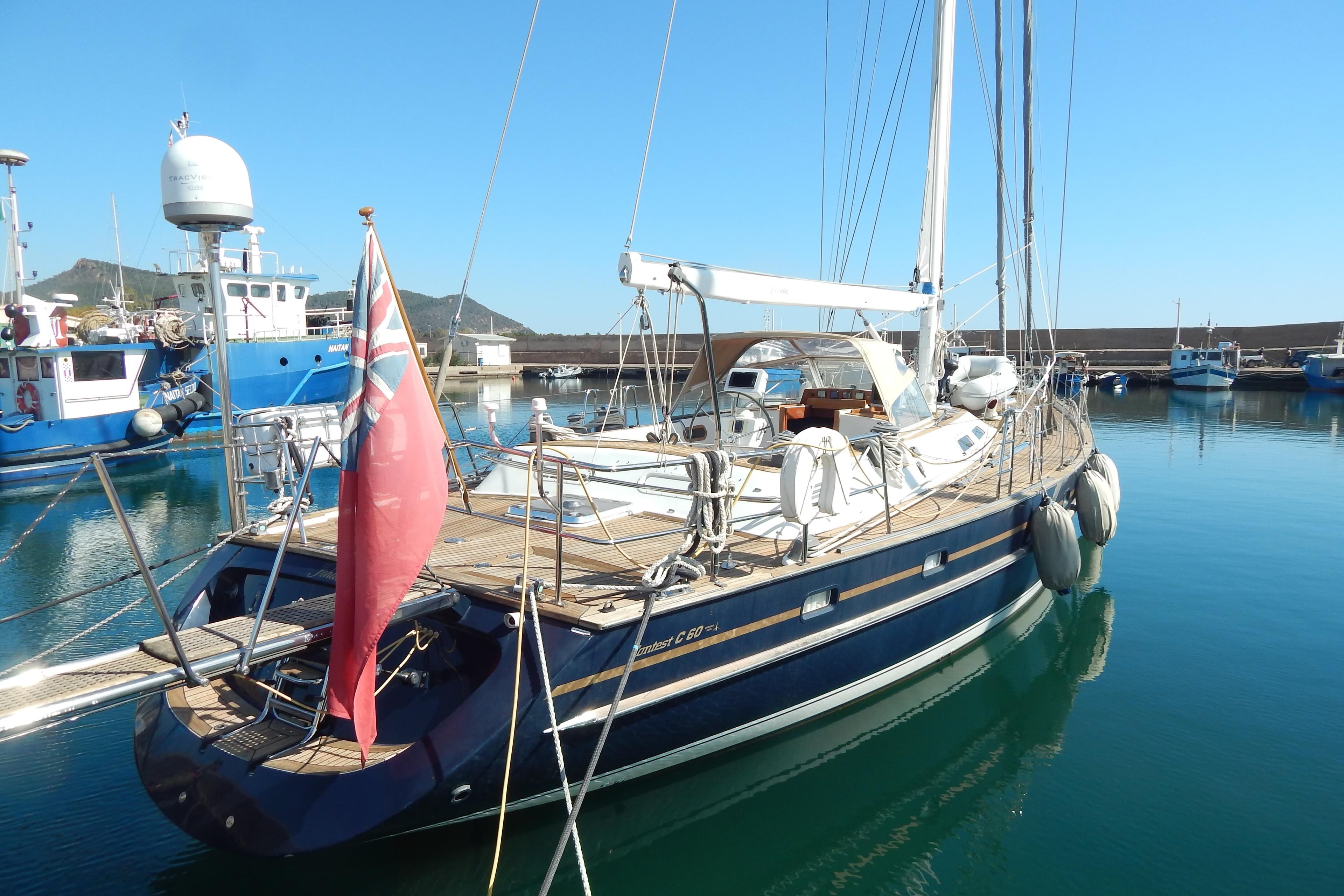 Luxury sailboat Contest 60 C, 2003 model, docked in a serene marina setting.