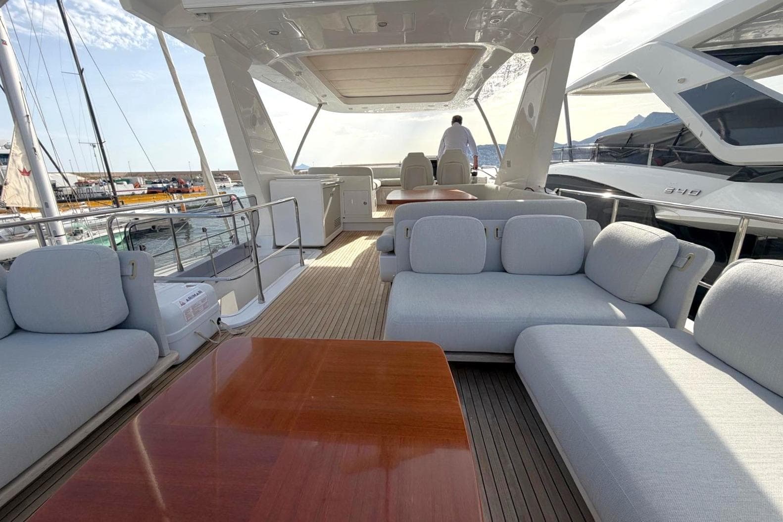 Luxurious 2021 Azimut 66 yacht deck with elegant seating and wooden table.