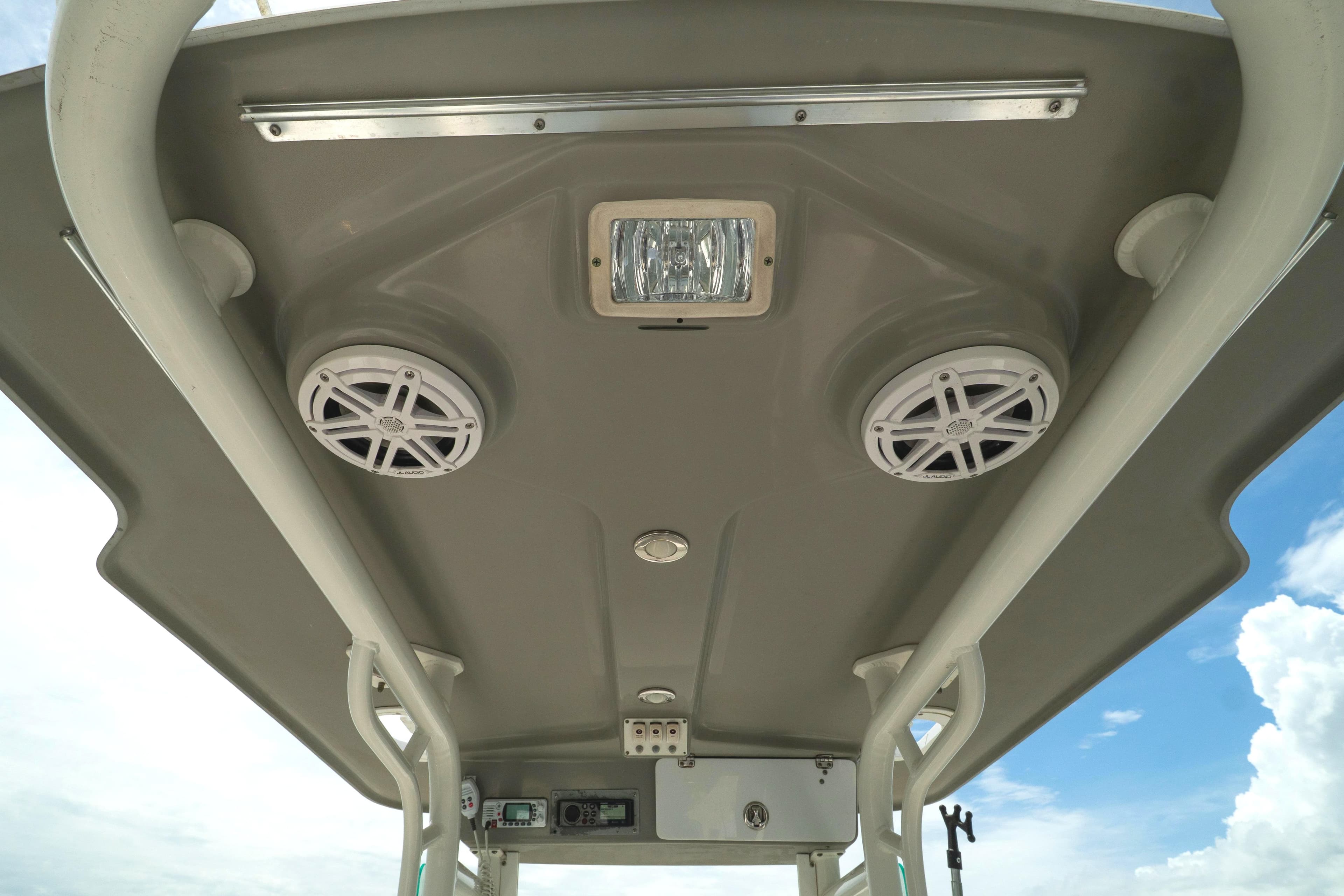2007 Everglades 243 Center Console boat roof with speakers and light fixtures.