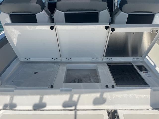 2023 Pursuit S358 boat interior with storage compartments and seating.
