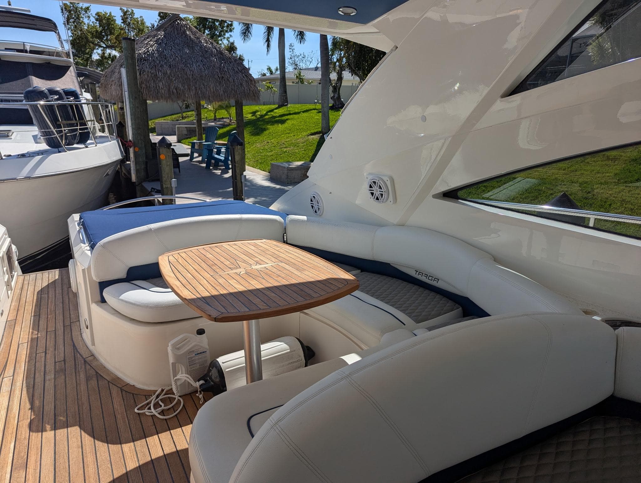 2007 Fairline Targa 52 GT yacht with elegant seating and wooden table on deck.