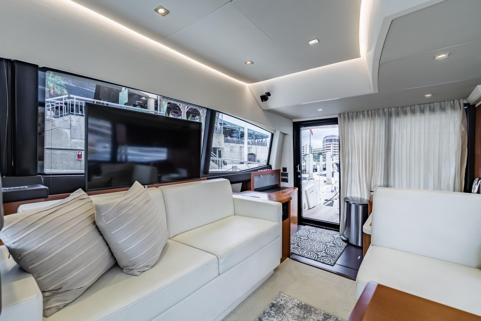 Luxurious interior of 2013 Prestige 500 Fly yacht with modern furnishings and large windows.