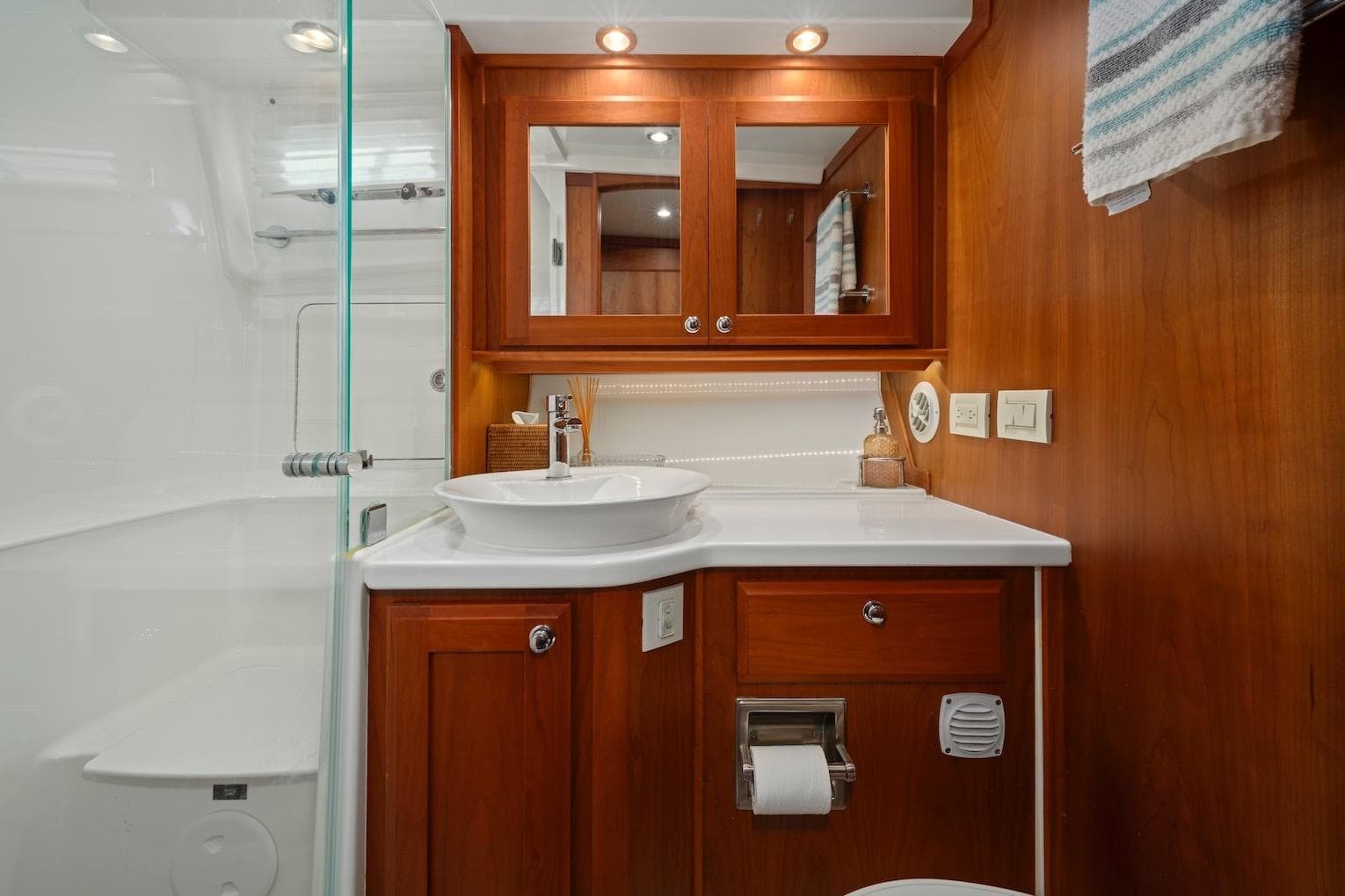Luxurious bathroom in 2019 Sabre 45 Salon Express yacht with wood cabinetry and modern fixtures.