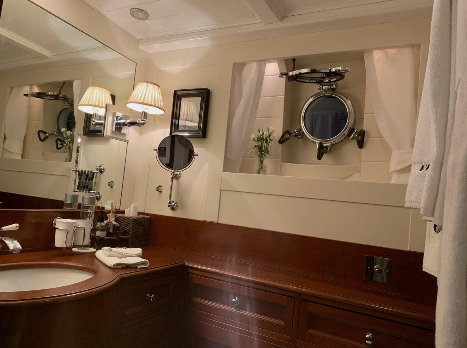 Luxurious 1939 Feadship Classic Yacht bathroom with elegant wood finish and nautical decor.