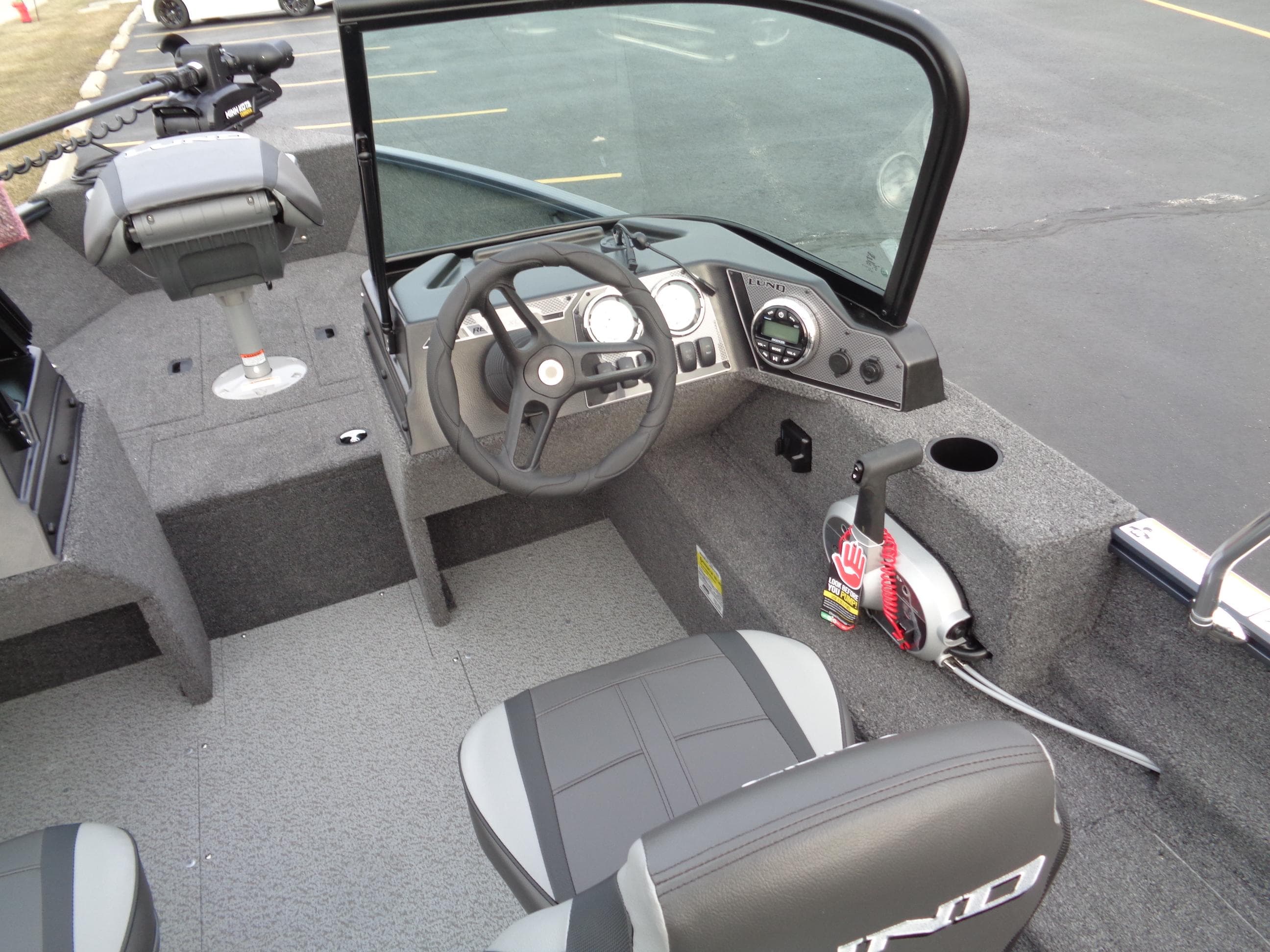 2024 Lund 1650 Rebel XL Sport boat interior with steering wheel and seating.