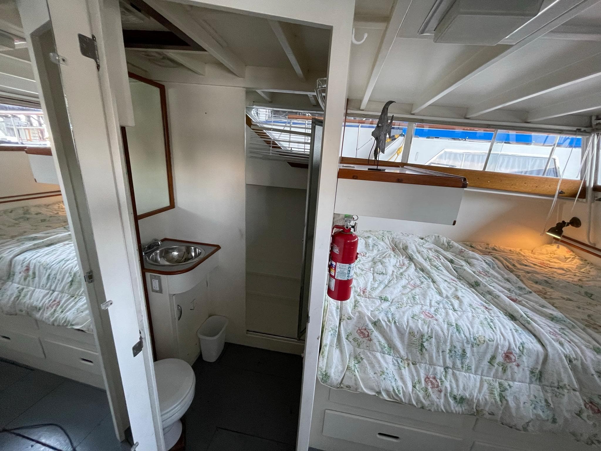 1961 Chris-Craft Conqueror cabin interior with bed, sink, and toilet.