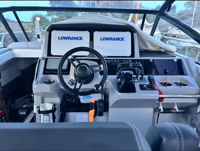 Helm of 2018 Jeanneau Cap Camarat 10.5 WA with Lowrance navigation displays.