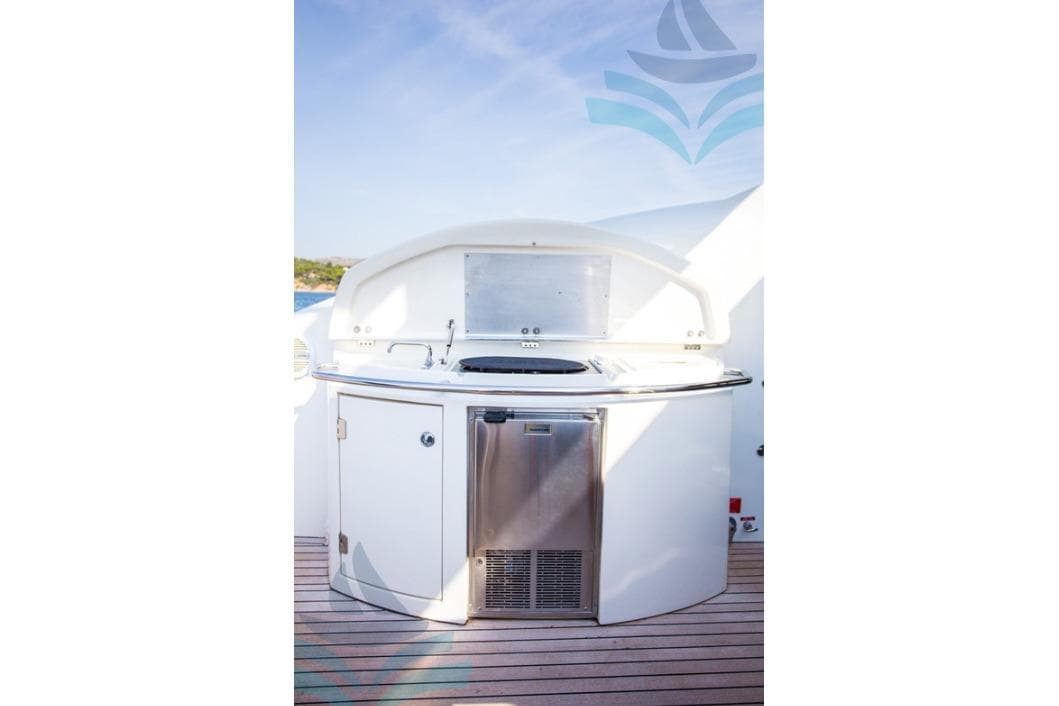 Outdoor kitchen on 2009 Sunseeker Predator 72 yacht, featuring grill and stainless steel appliances.