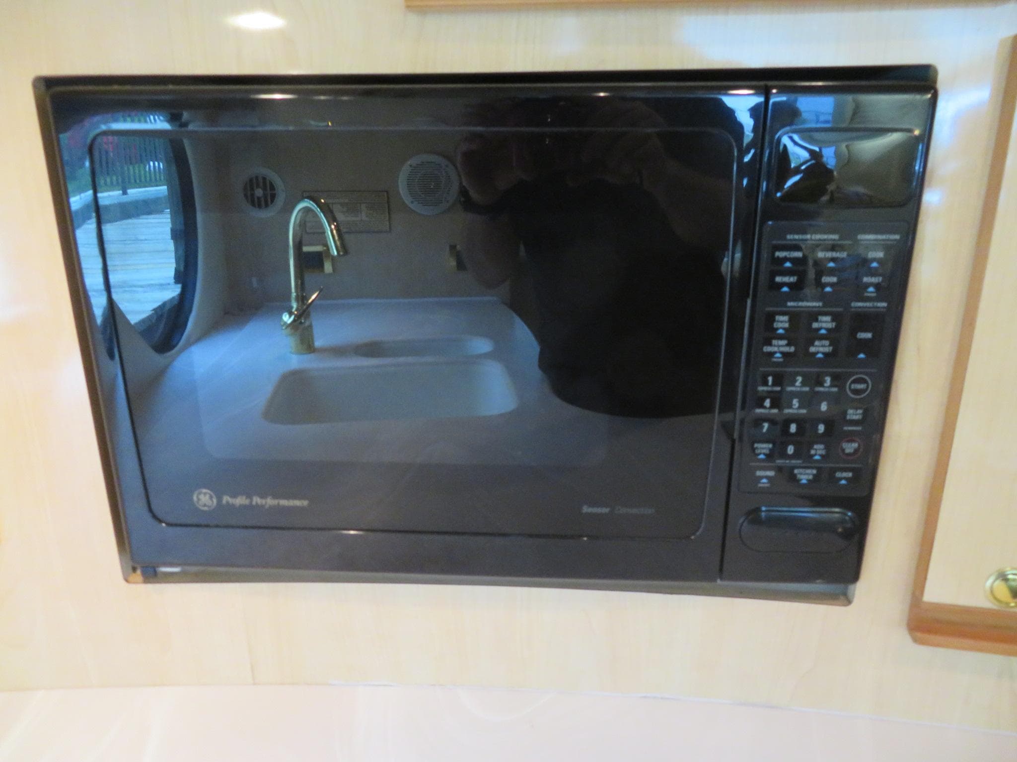 Built-in microwave in the kitchen of a 2000 Bluewater Yachts 5800 Motor Yacht.