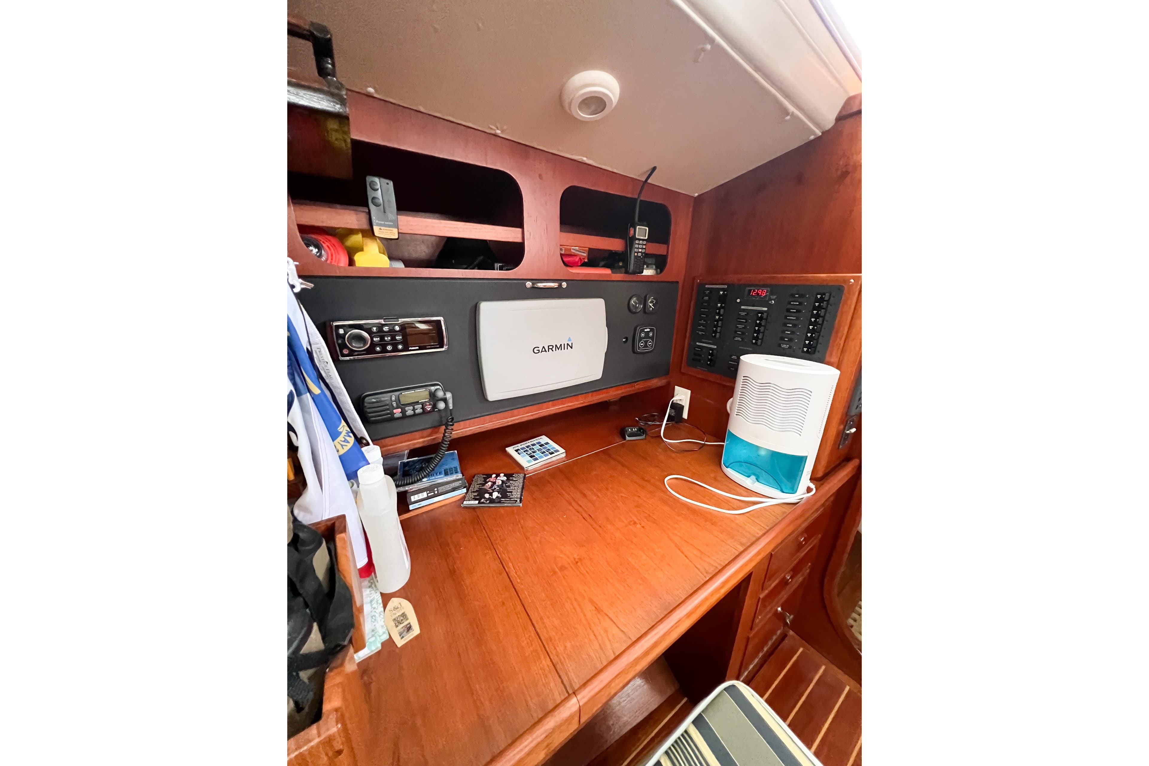 Navigation station on 1984 Trintella 42 yacht with Garmin equipment and control panel.