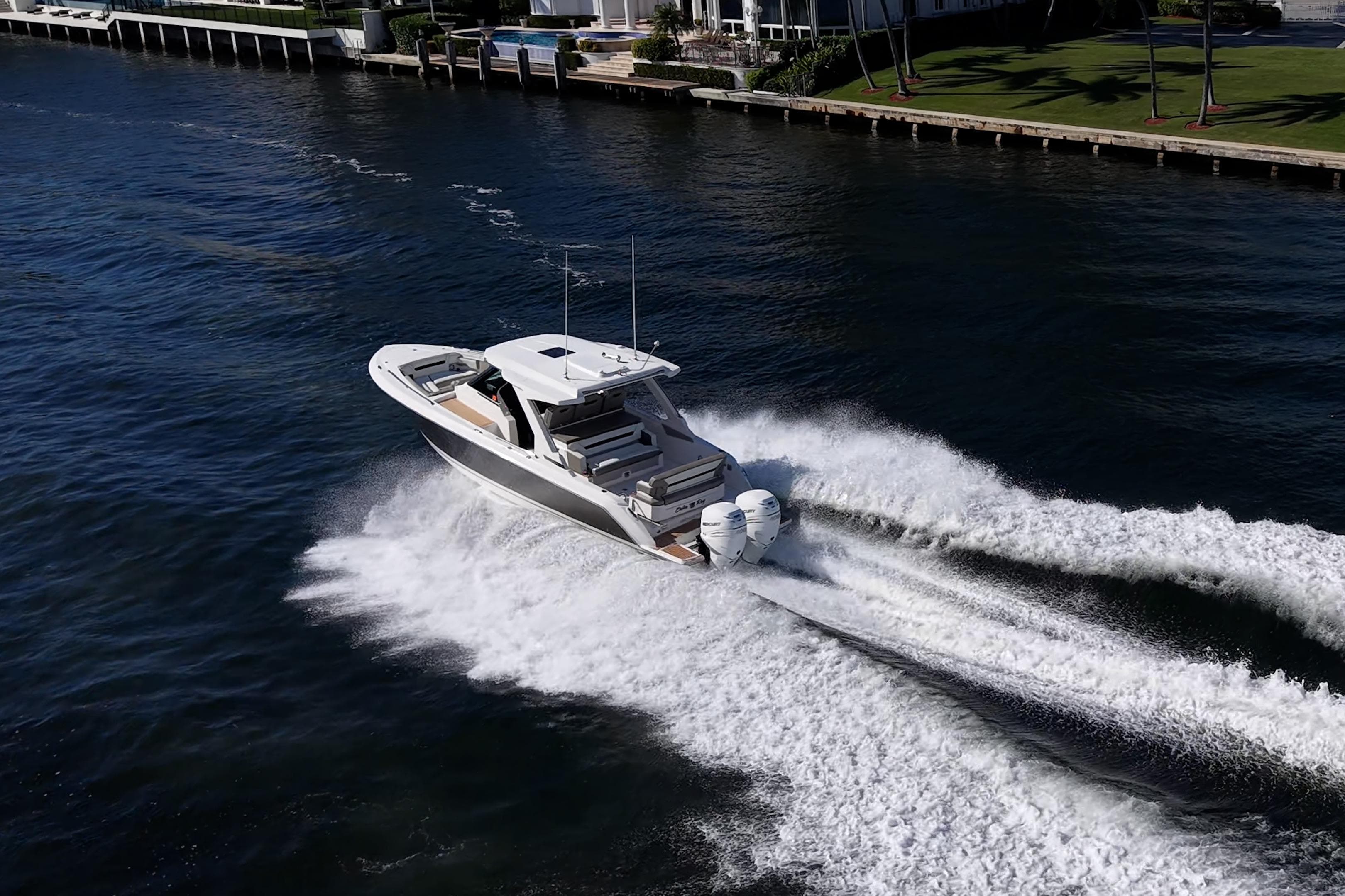 2023 Tiara Yachts 34 LS cruising on water, creating dynamic wake.