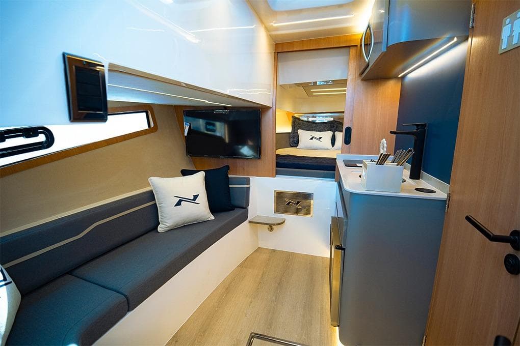Luxurious interior of 2025 NX Boats NX41 HORIZON with modern seating and kitchenette.