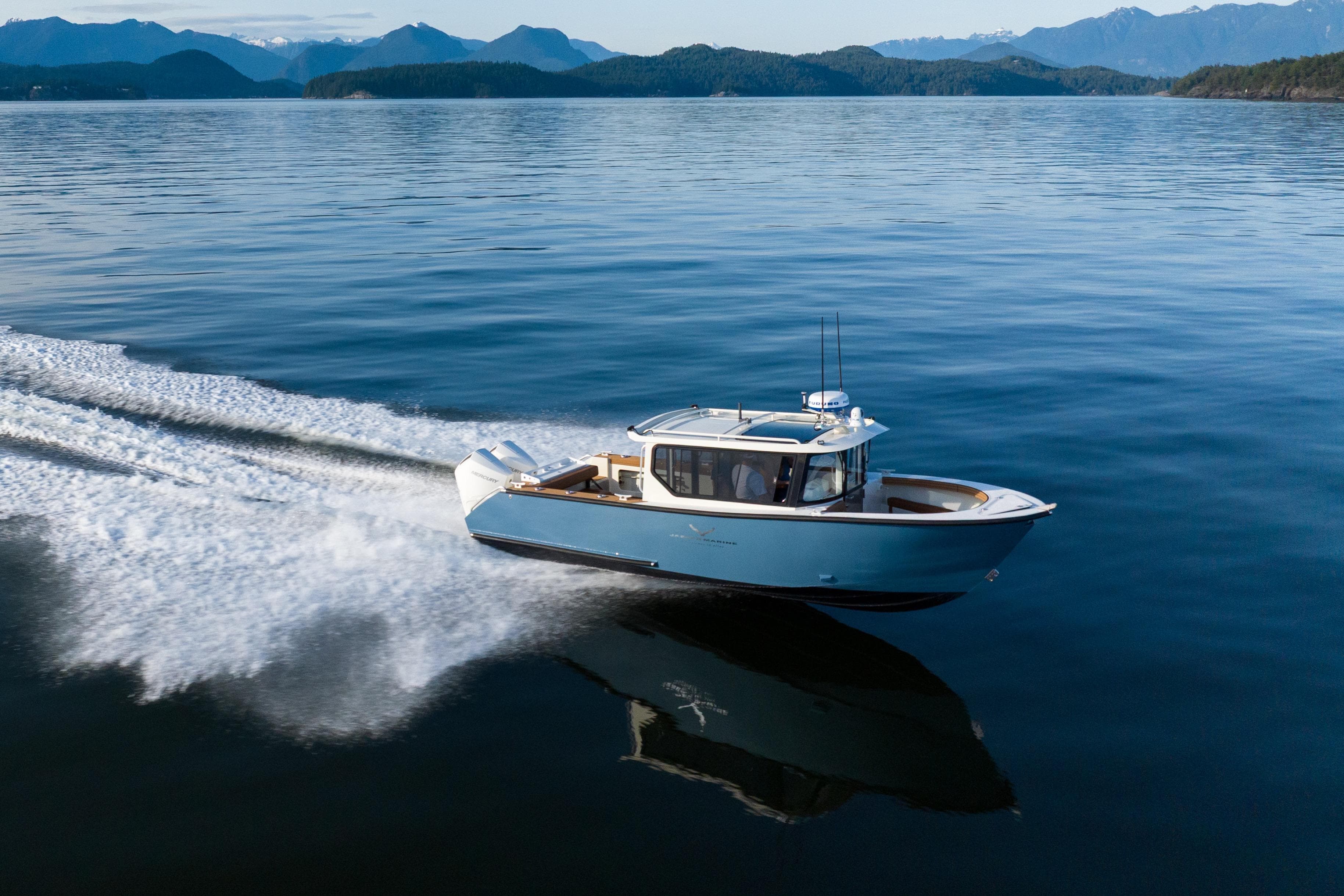 2026 Jasper Marine Defender 22 cruising on a serene lake with mountainous backdrop.