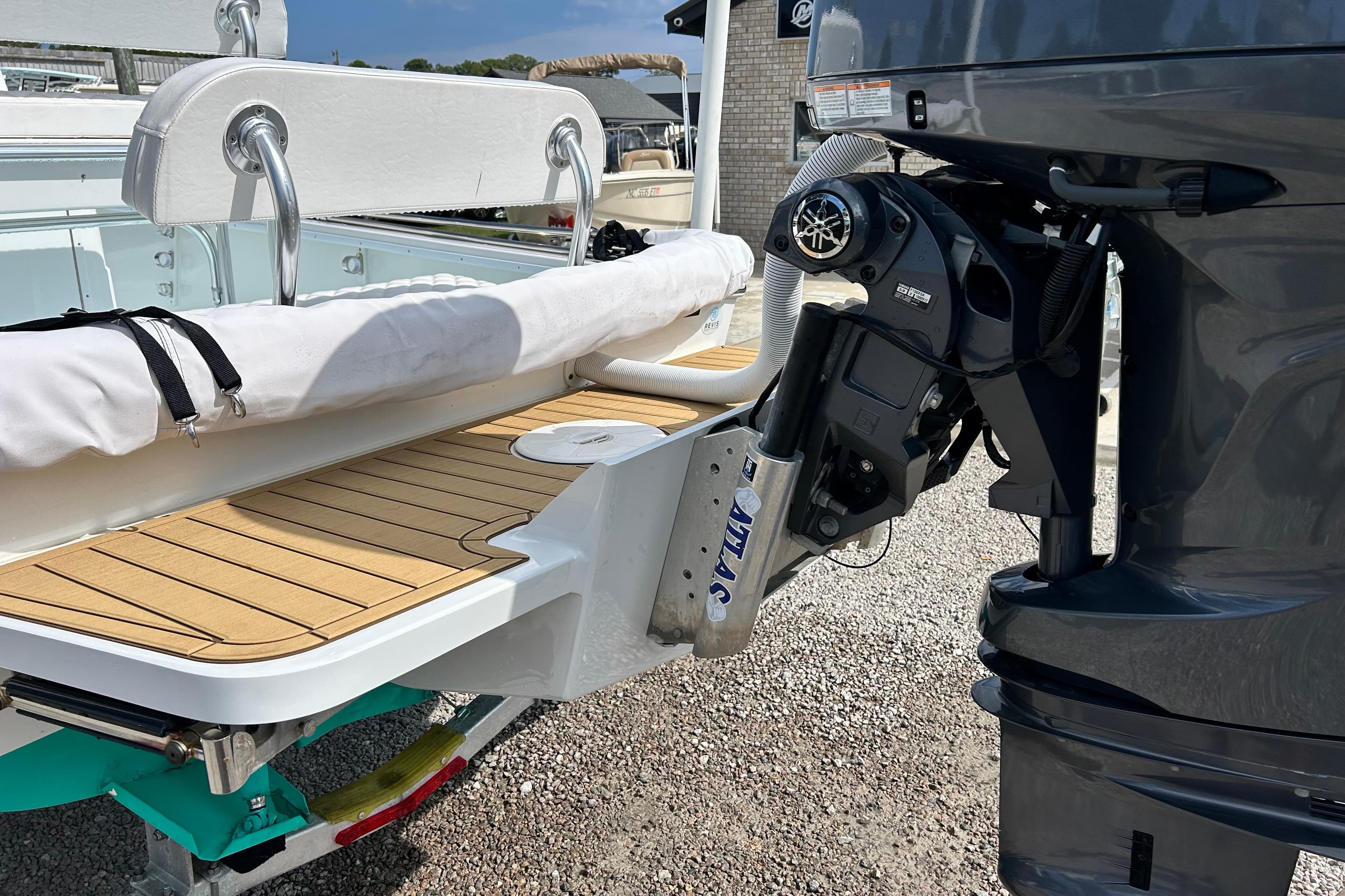 2025 Dragonfly Boatworks Spanish Wells 21 with outboard motor and teak deck detail.