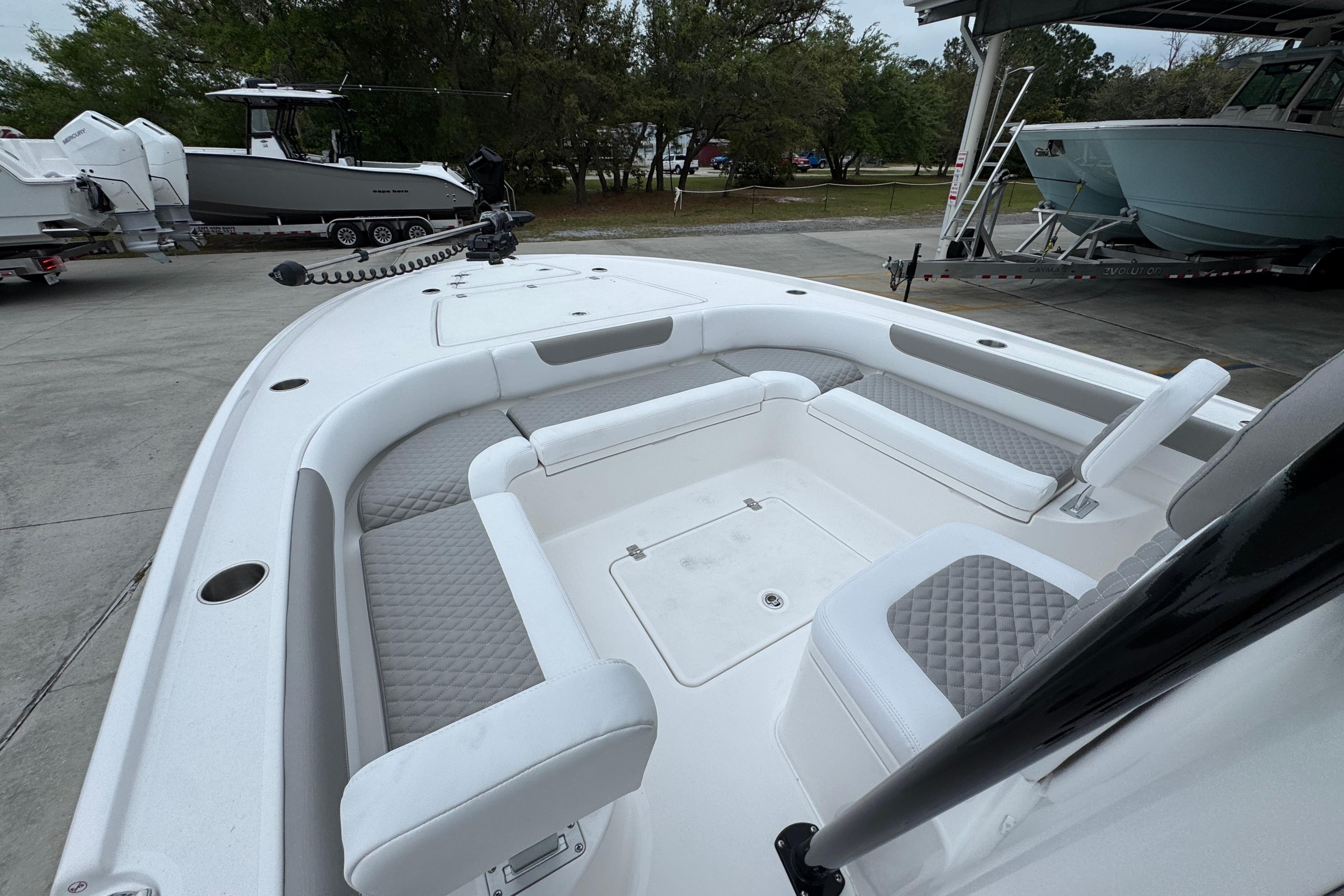 2026 Caymas 26 HB boat with spacious seating and modern design in a marina setting.