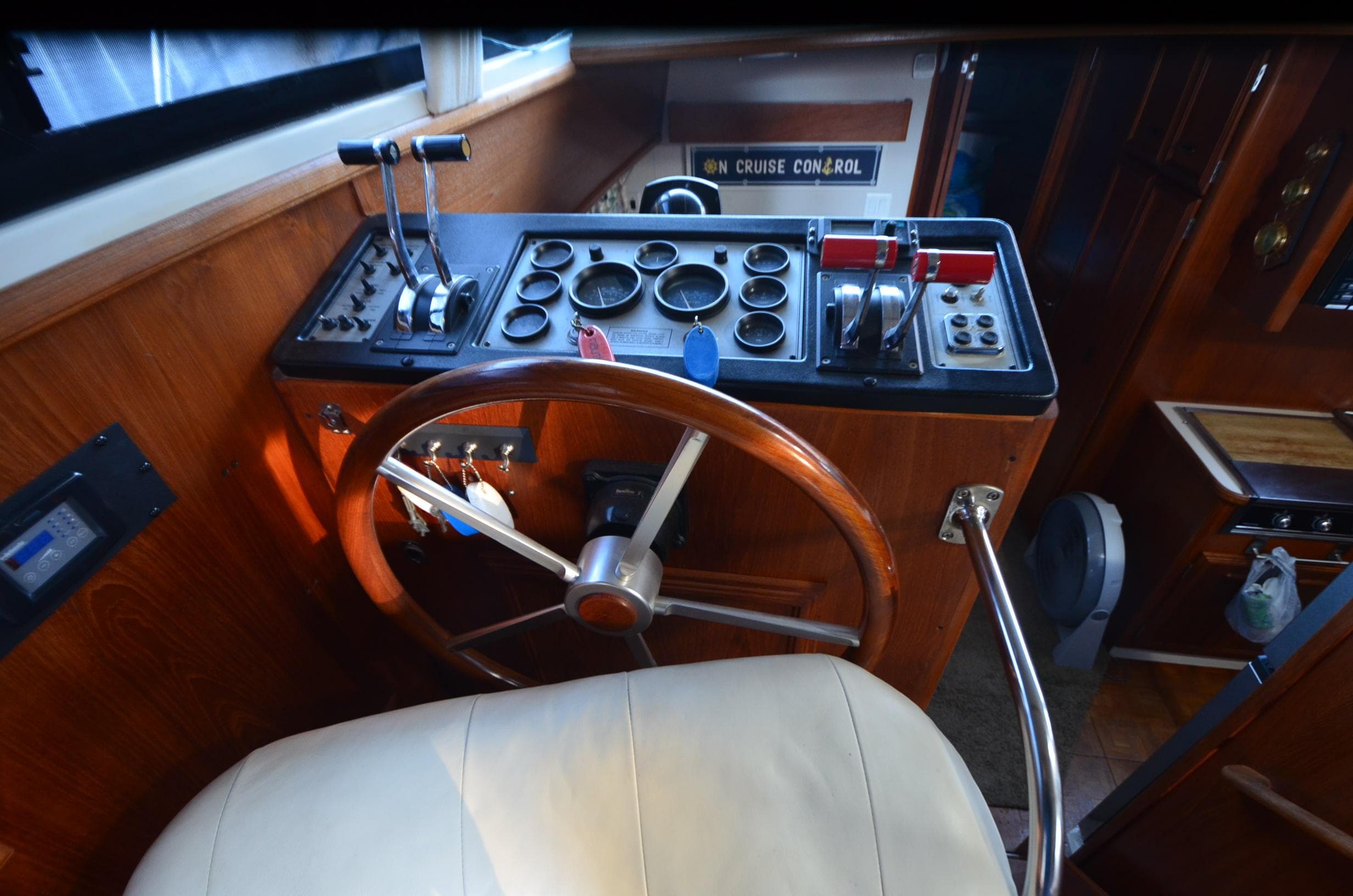 1988 Carver 4207 Aft Cabin MY helm with wooden steering wheel and control panel.