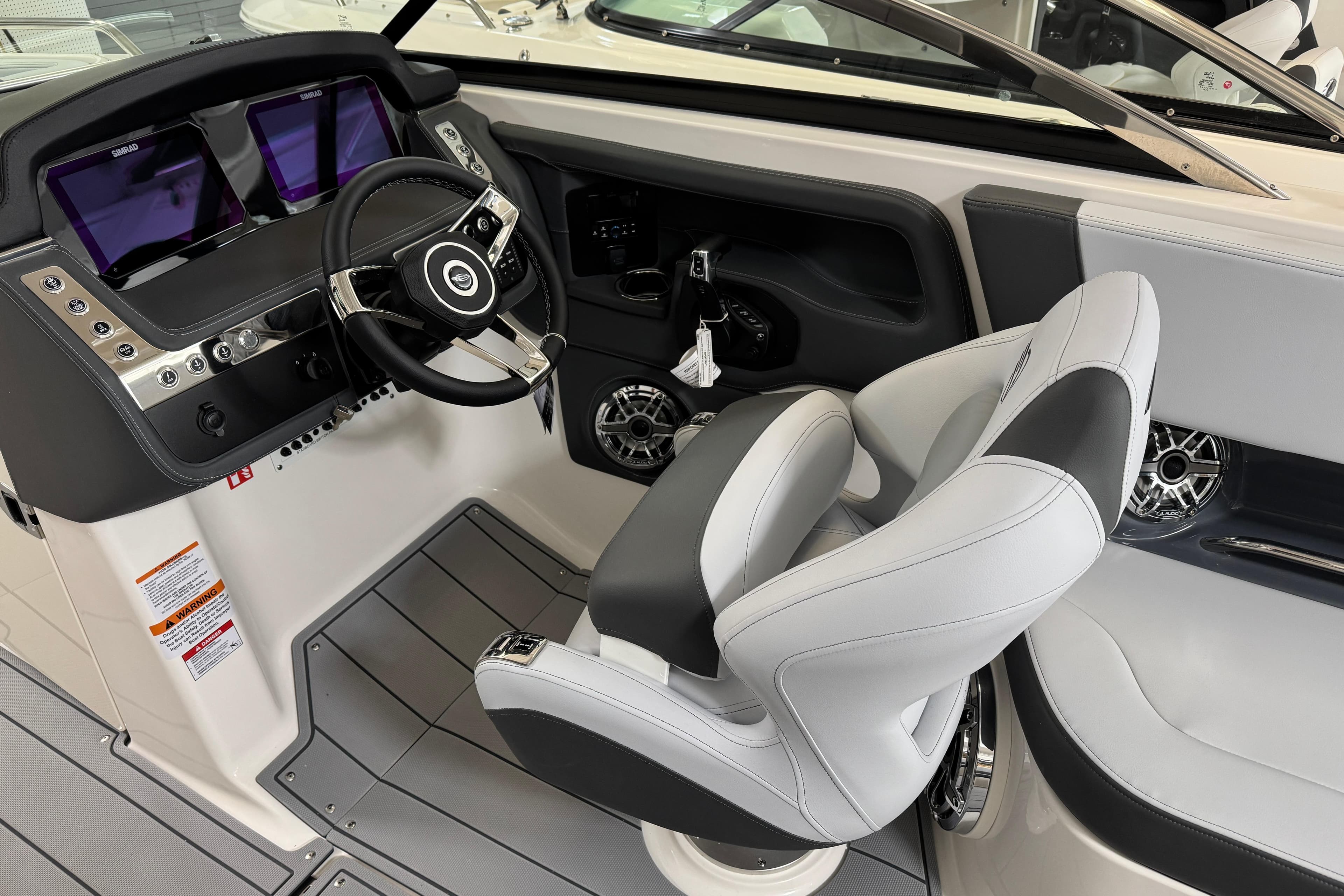 2026 Chaparral 270 OSX boat cockpit with modern steering and dual displays.