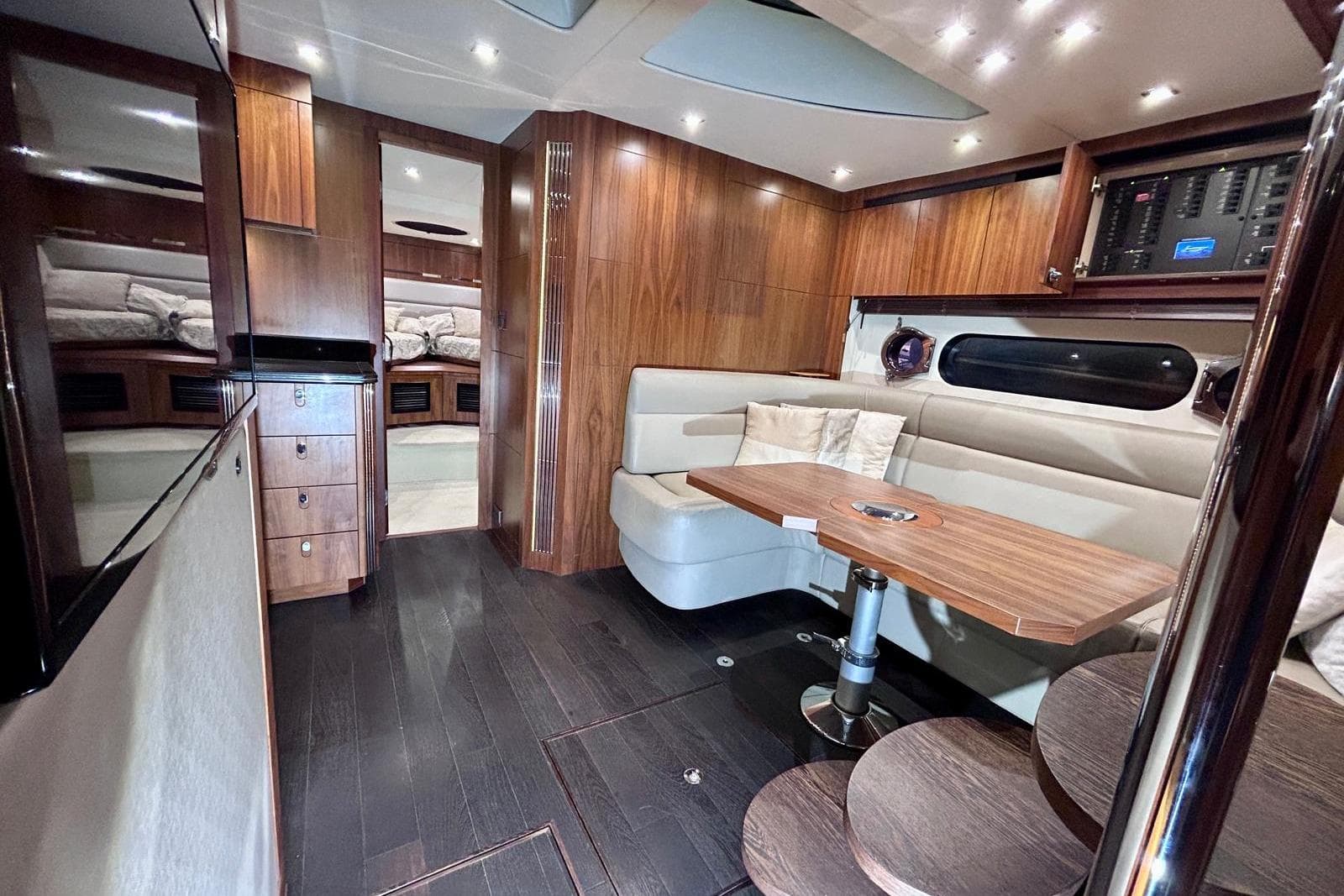Luxurious interior of 2014 Sunseeker San Remo 485 yacht with wood finishes and cozy seating.