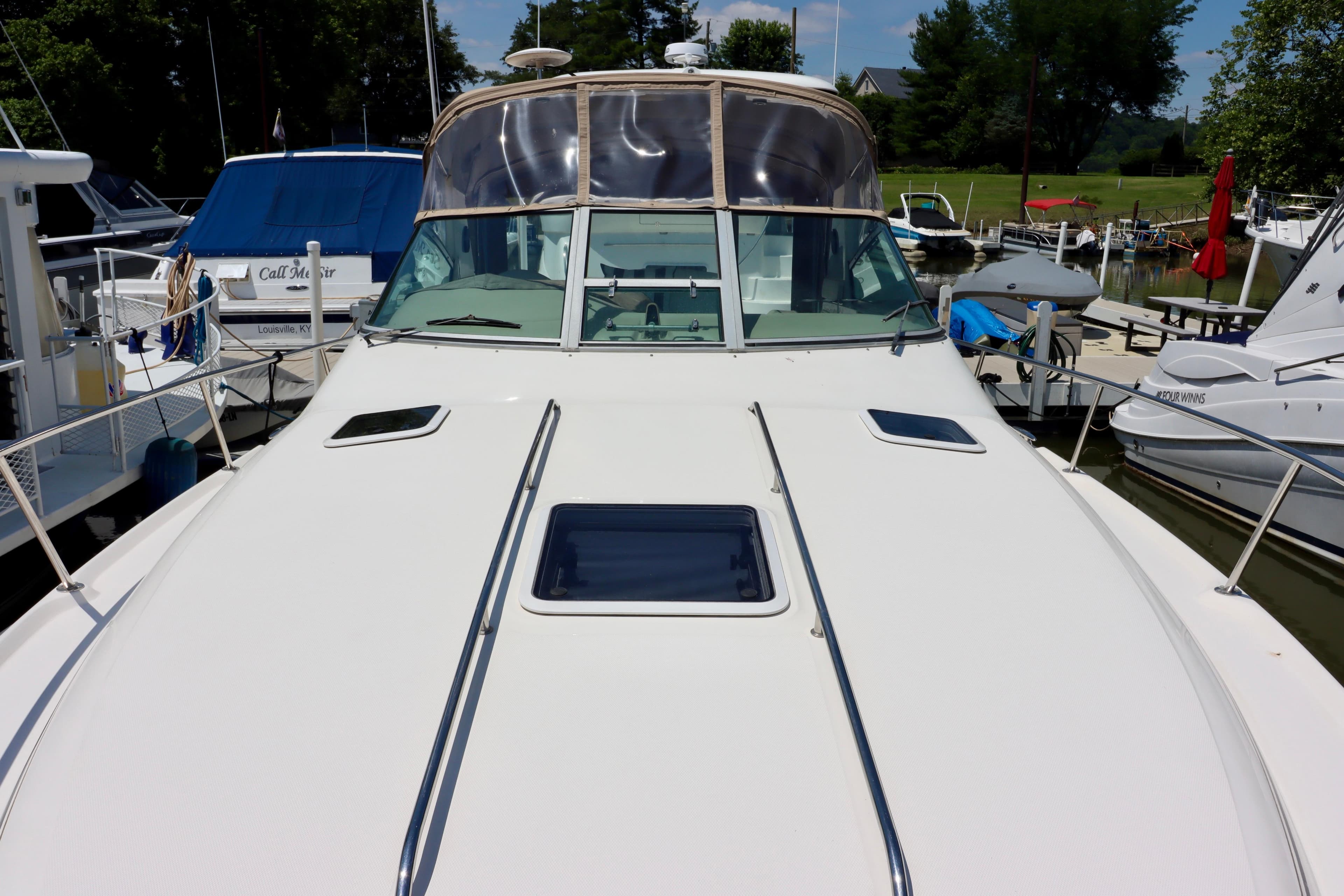 2001 Sea Ray Sundancer 310 yacht docked at marina, showcasing sleek design and spacious deck.